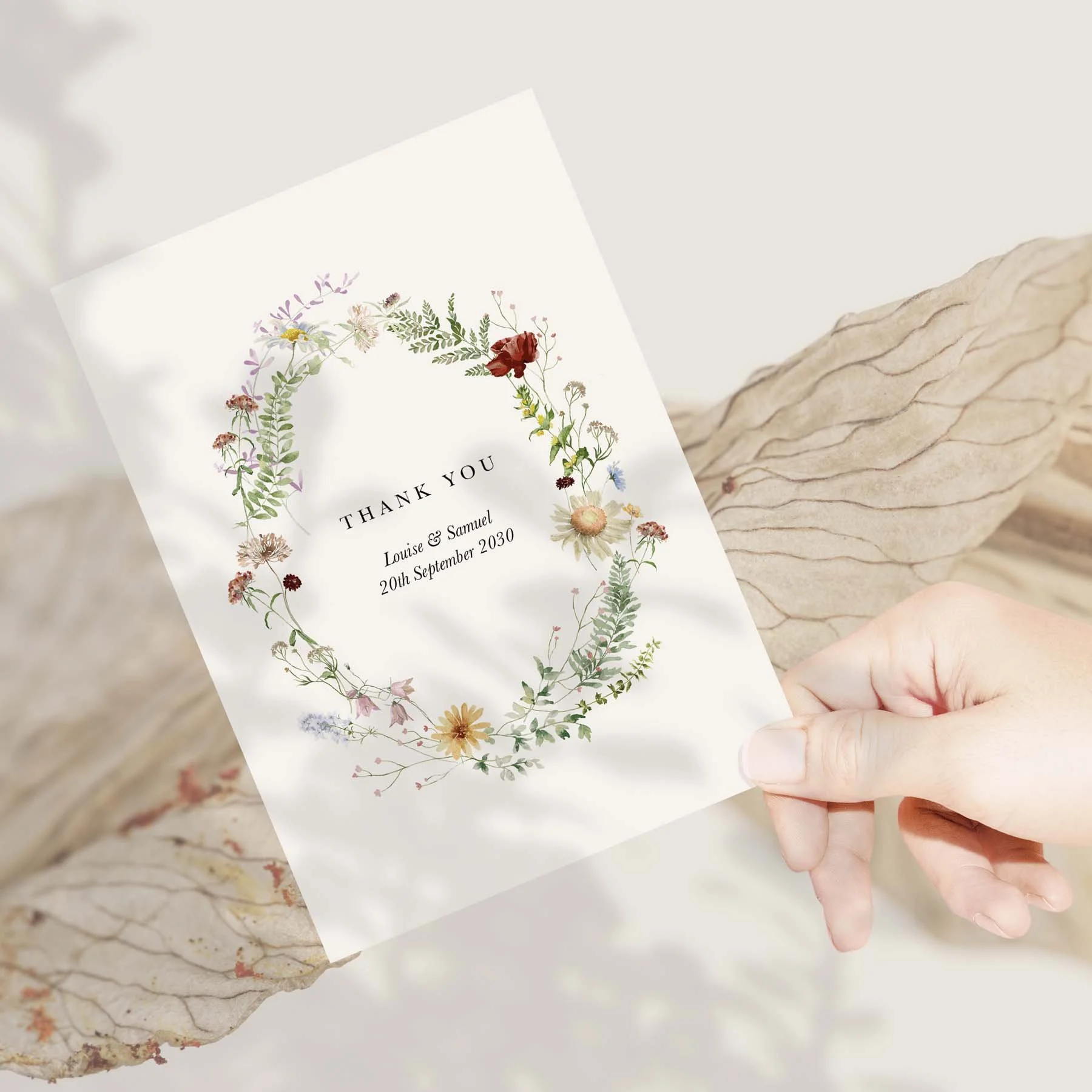 Hand holding a Meadow Flowers wedding thank you card