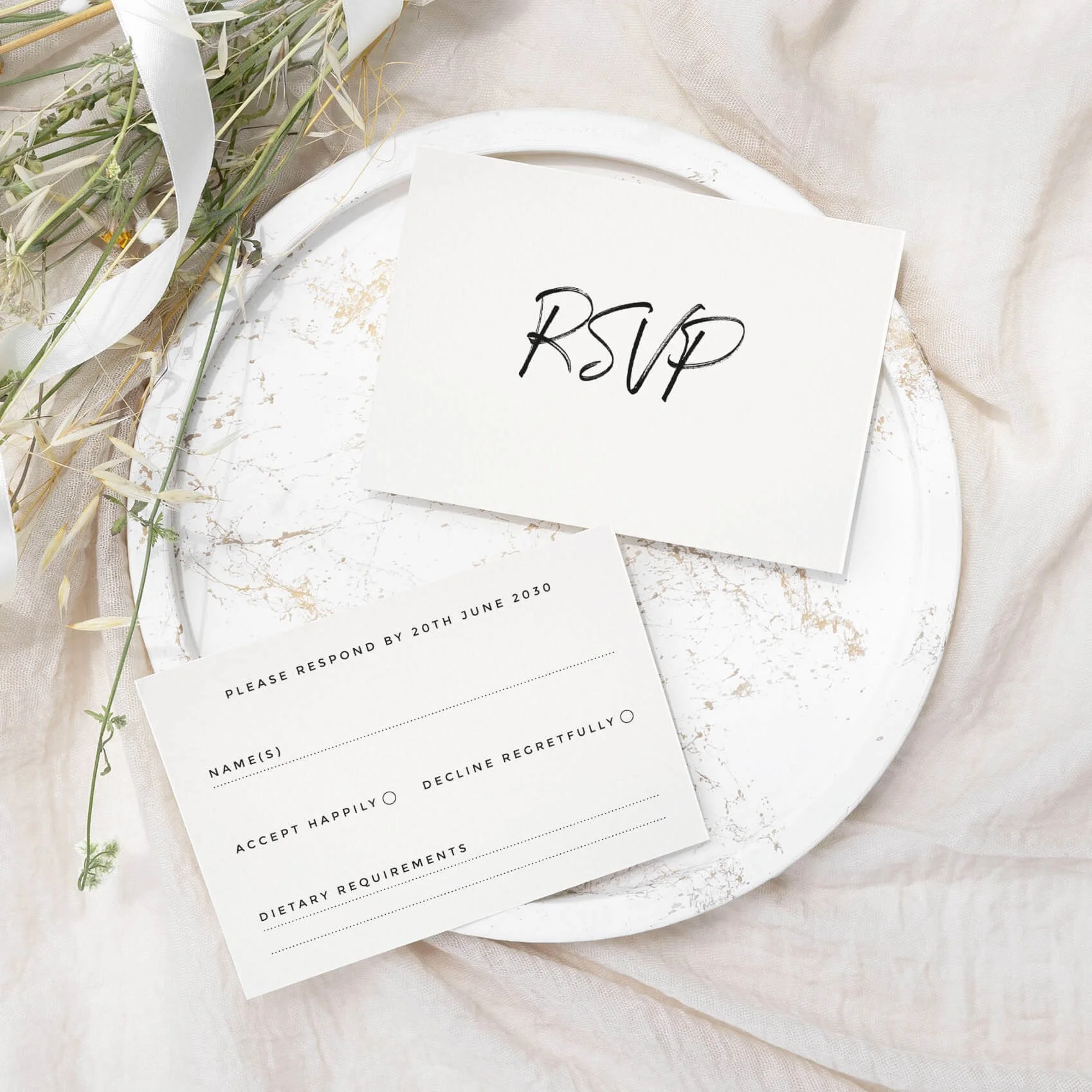 Signature wedding RSVP card with elegant handwritten script and serif typography on luxury off-white card