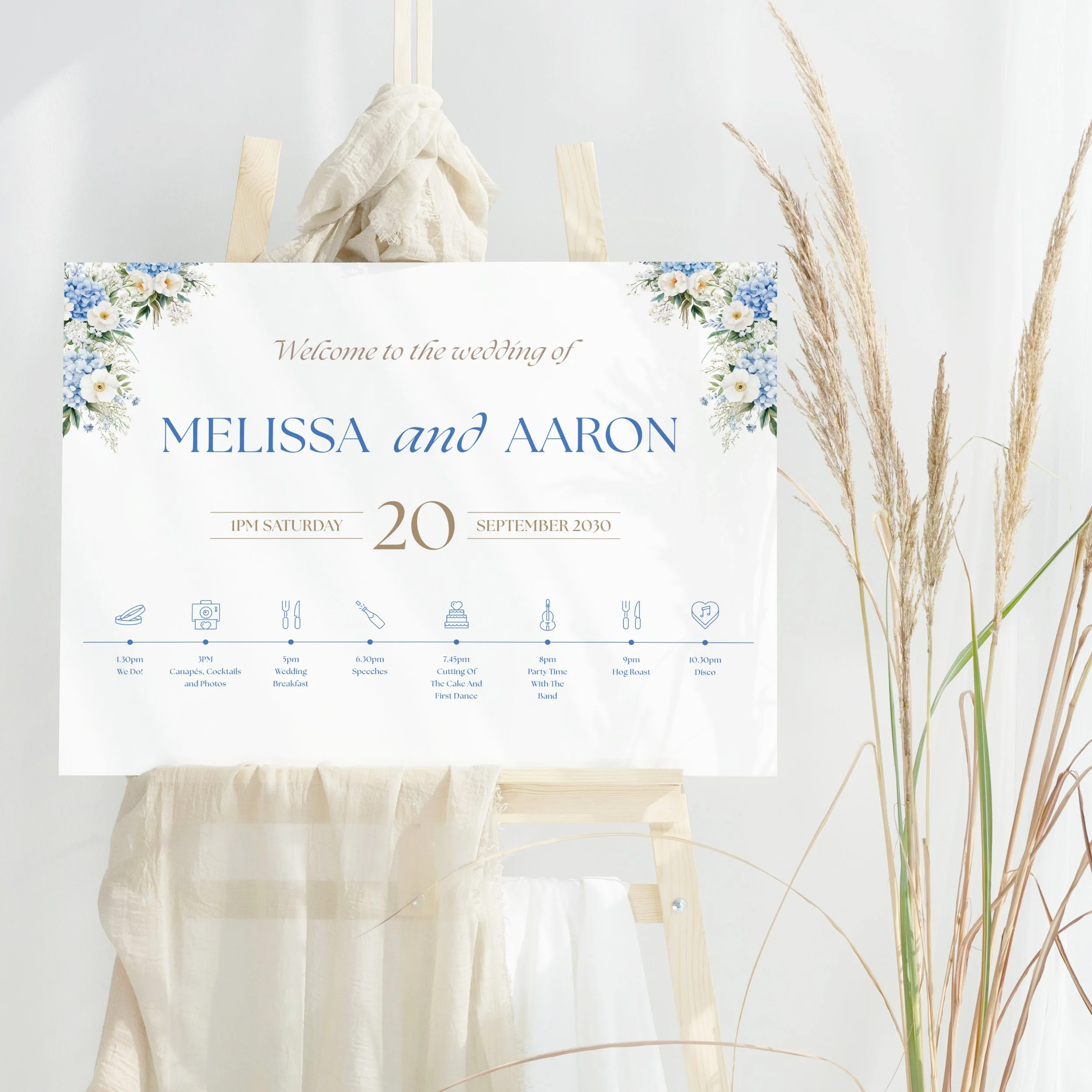 Serenity Wedding Welcome Sign with blue florals in top corners and Order of the Day timeline printed on board.
