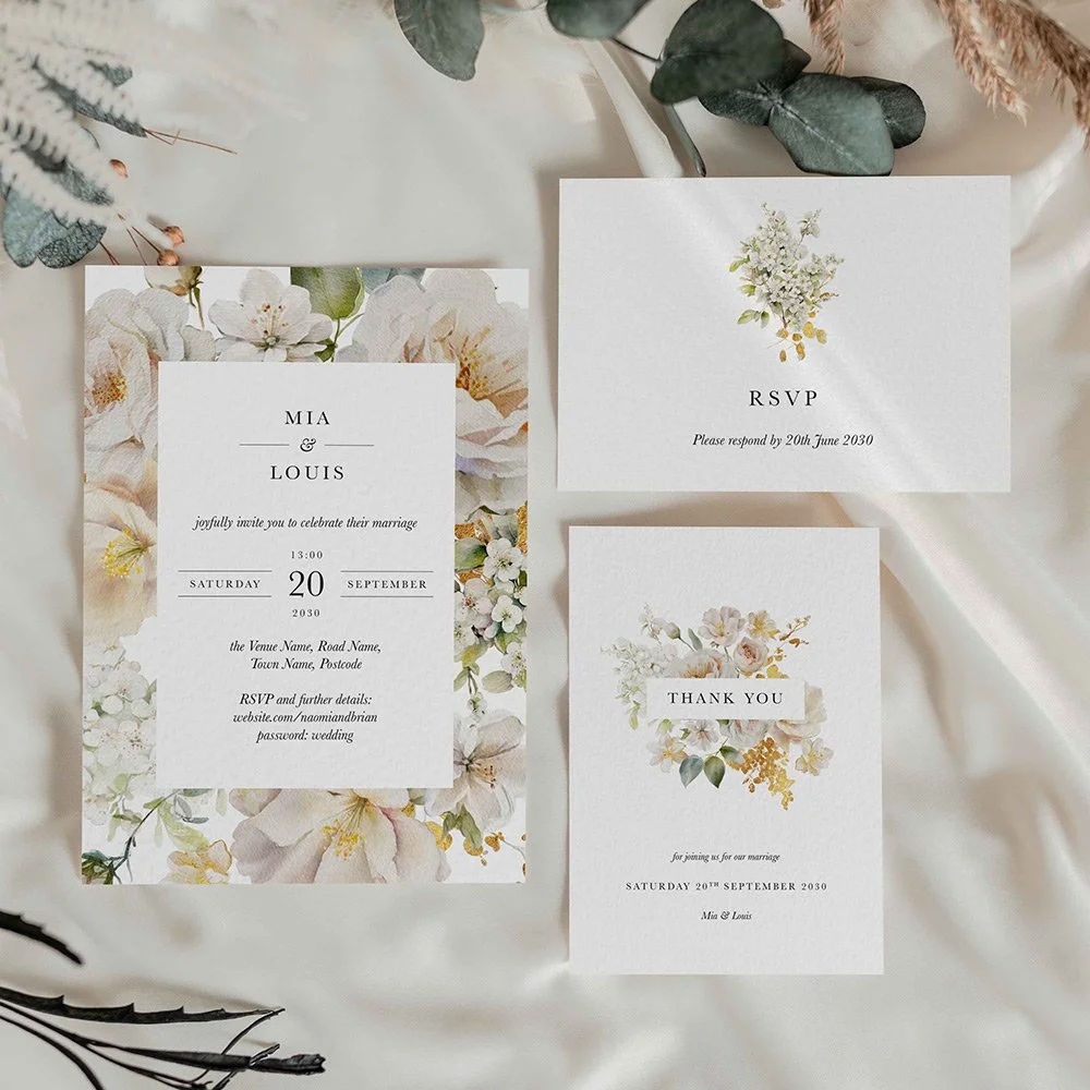 Ethereal Wedding invitation card with soft white and gold florals arranged in a frame layout
