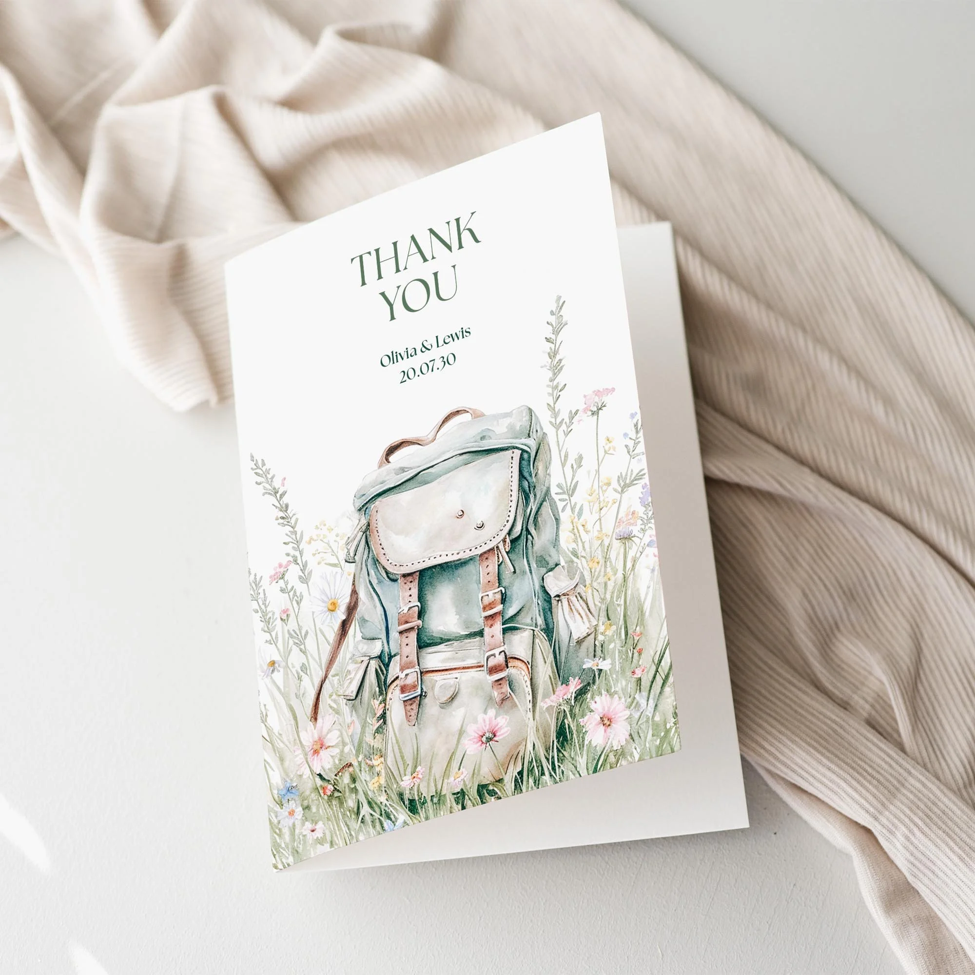 Adventure Wedding Thank You Card featuring a backpack and wildflowers on a scenic walk.