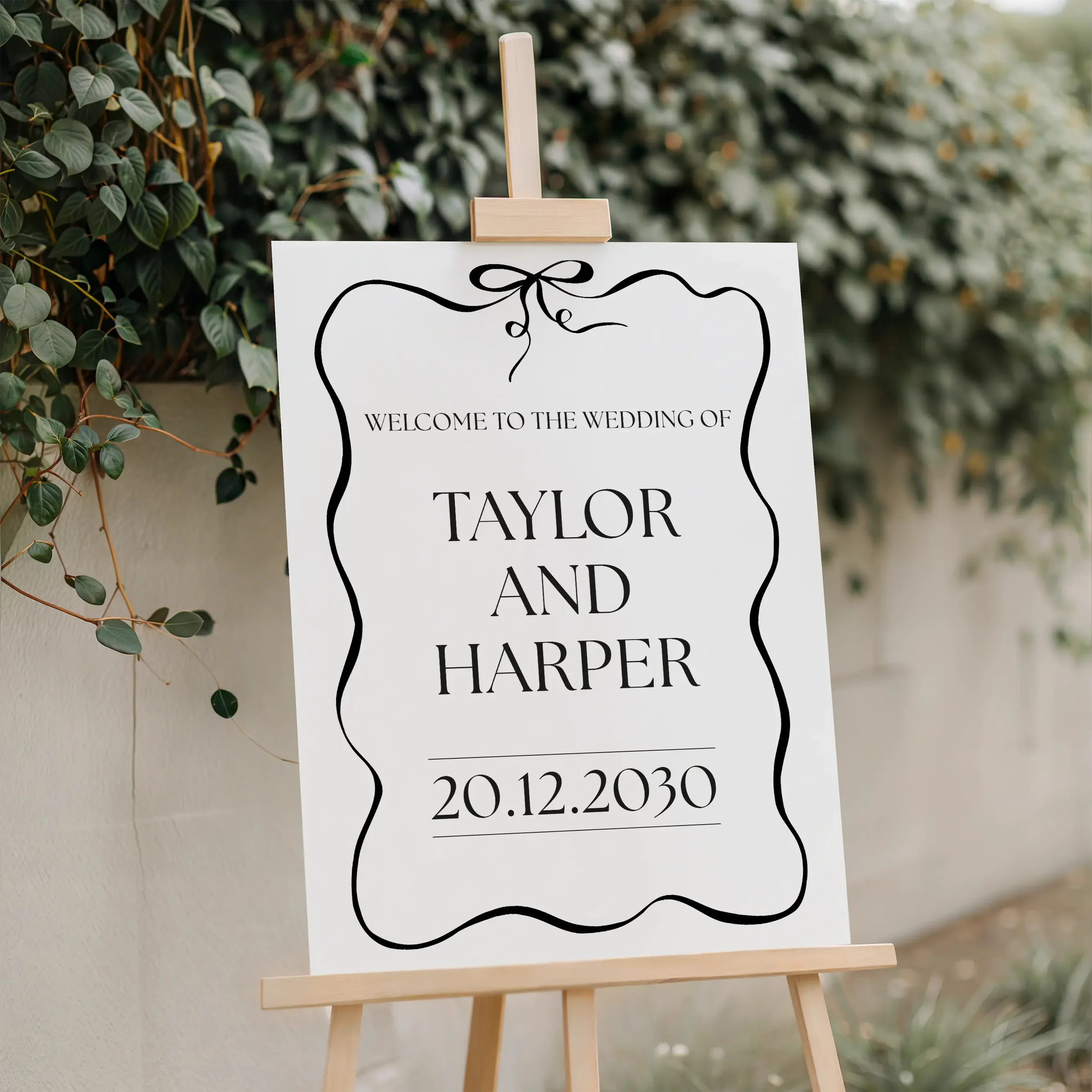 Black Tie Welcome Sign on an easel outside a formal wedding venue.