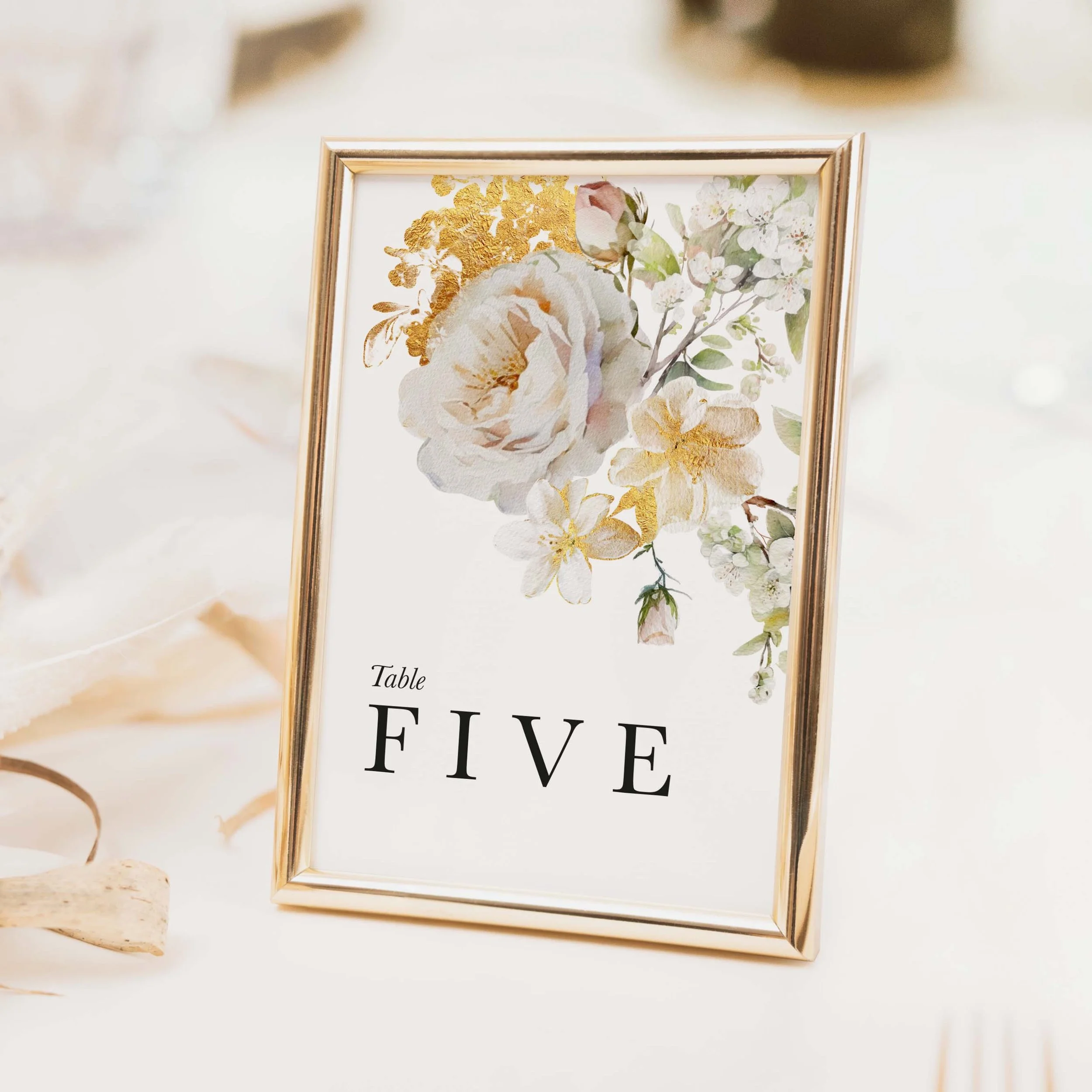 Ethereal wedding table number with soft watercolour rose and peony illustration in blush tones and bold serif typography on luxury off-white card