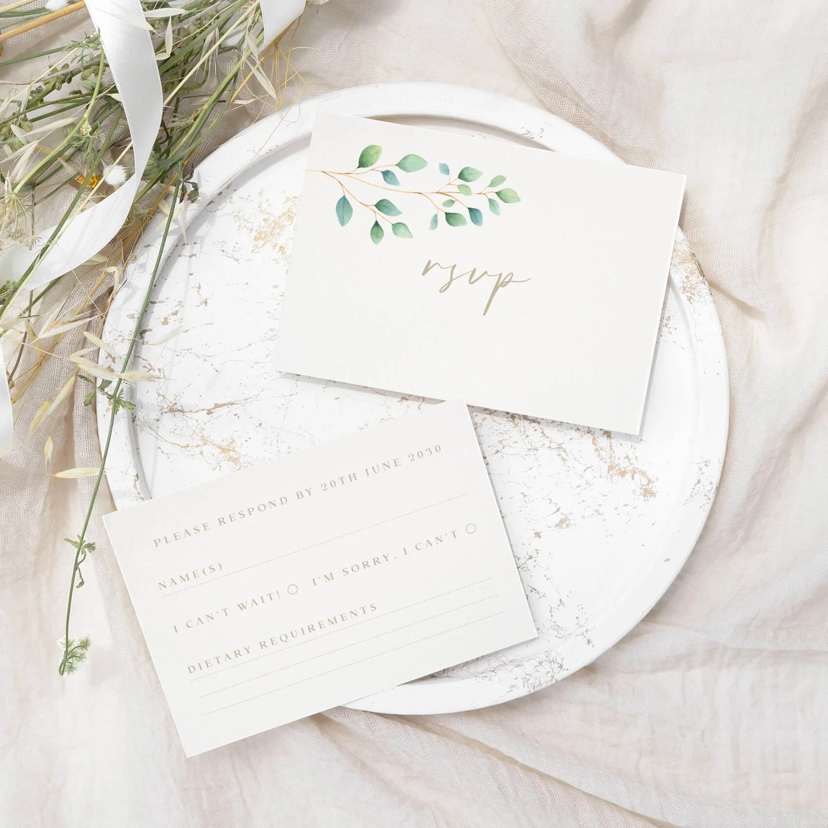 Eucalyptus foliage calligraphy wedding RSVP card with greenery detail and response fields on luxury off-white card