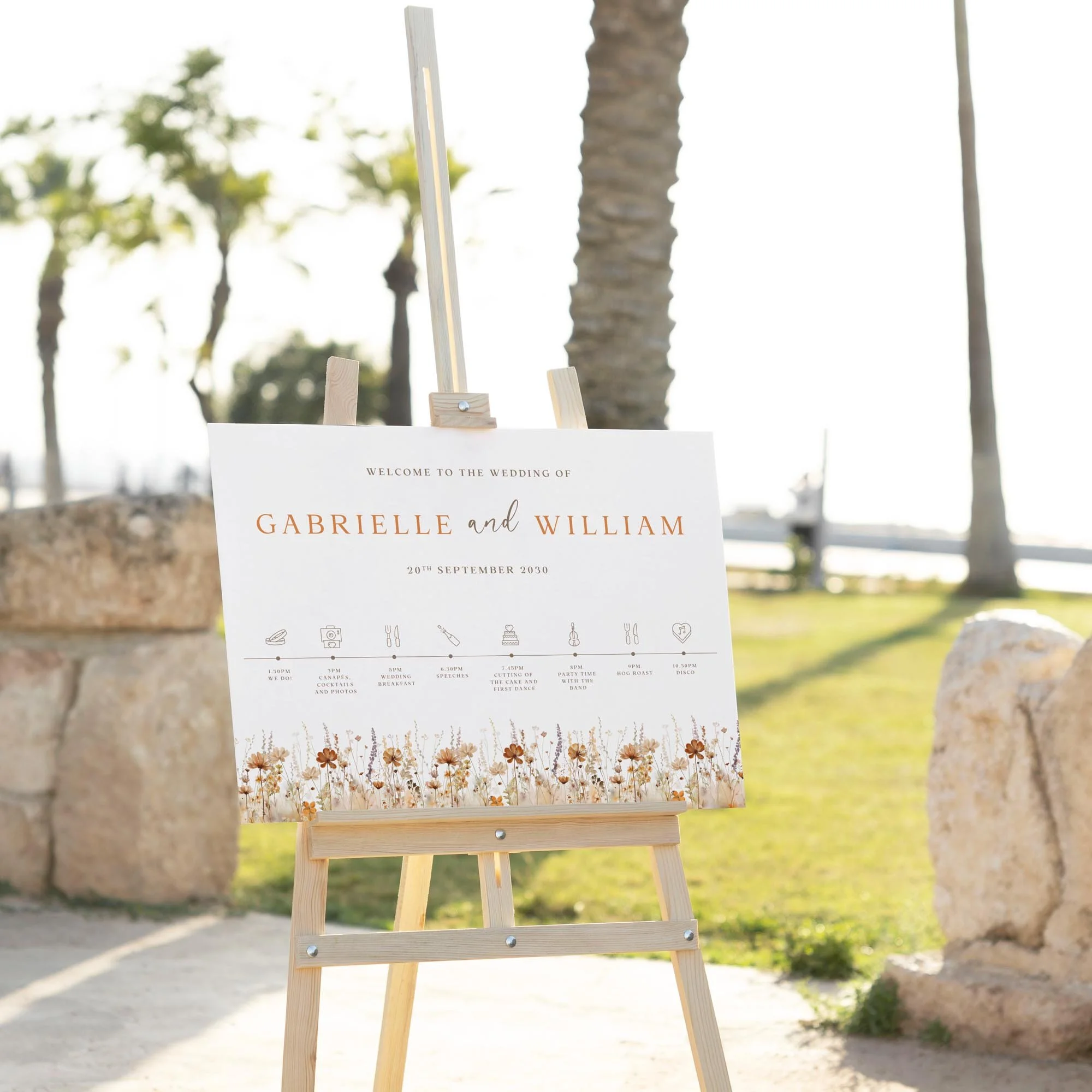 Earth Tone Wildflower wedding welcome sign displayed outdoors at a wedding venue on an easel