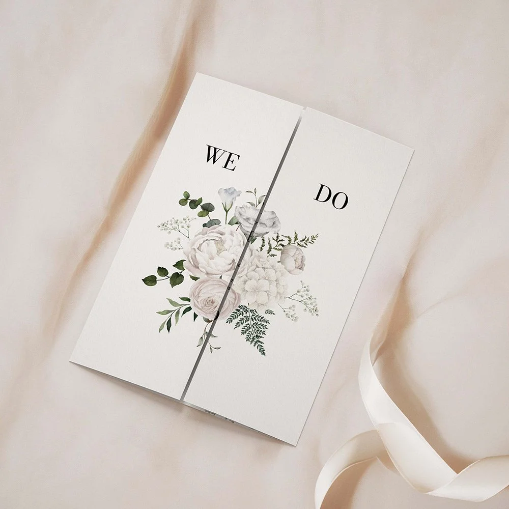 White Floral Collection gatefold wedding invitation closed, showcasing soft white and ivory florals with delicate greenery accents.