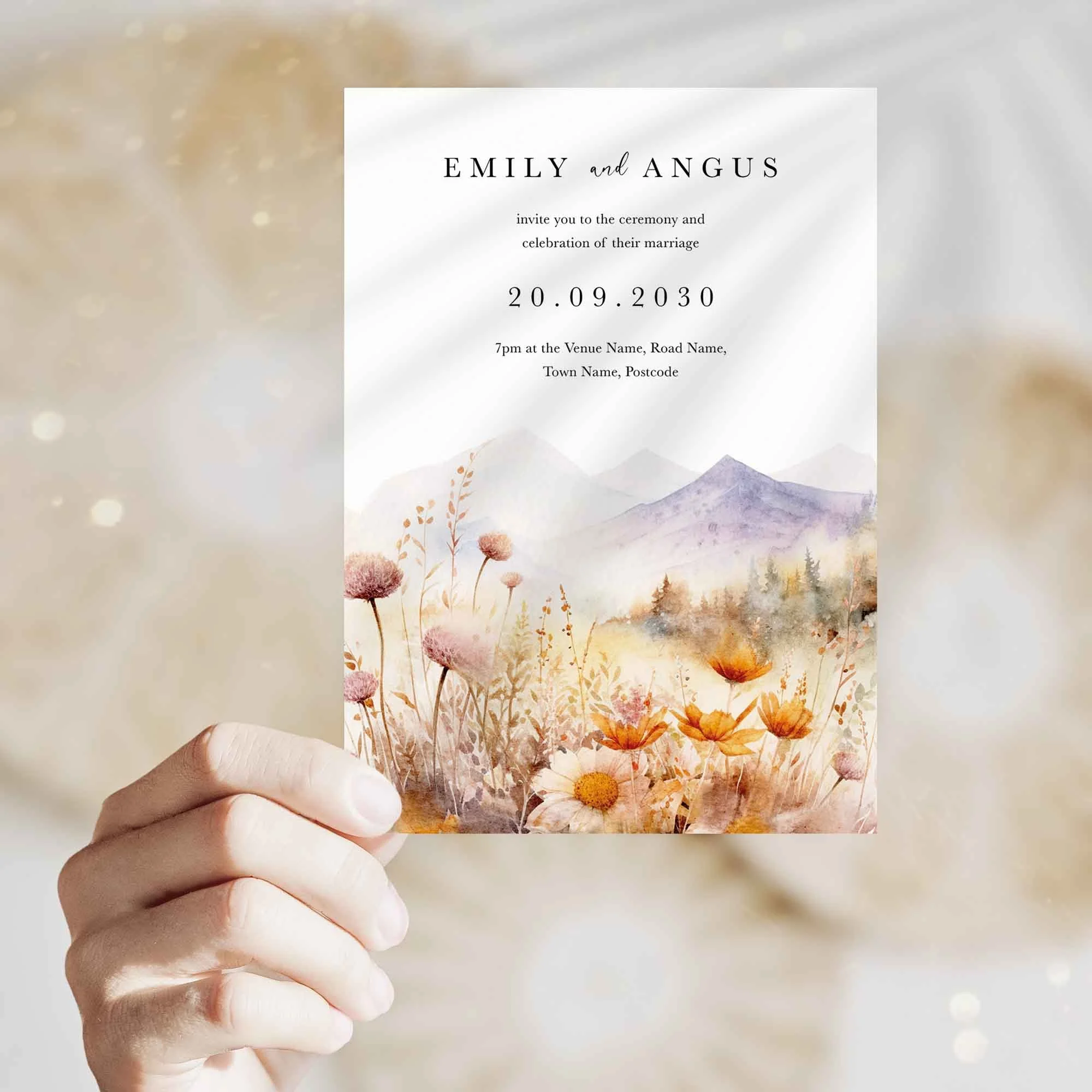 Hand holding Floral Fields with Mountains wedding invitation showing size and printed design details