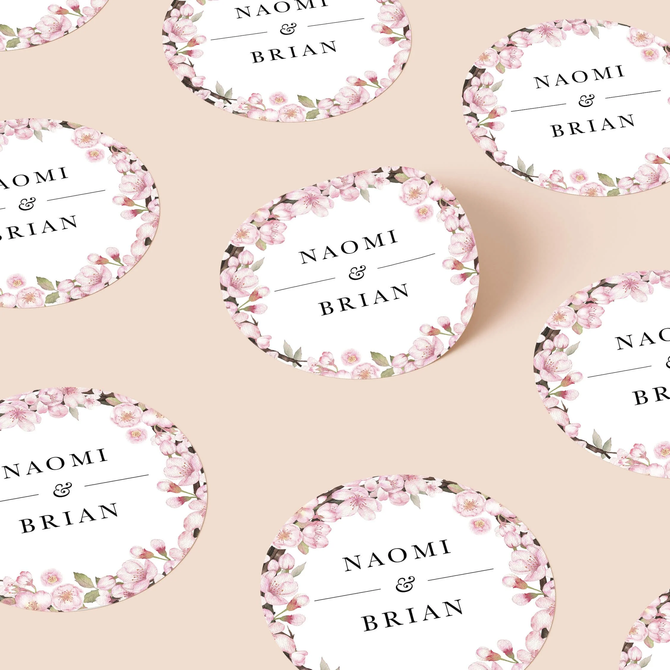 Cherry blossom wedding stickers with pink floral border and initials repeated on personalised round seals