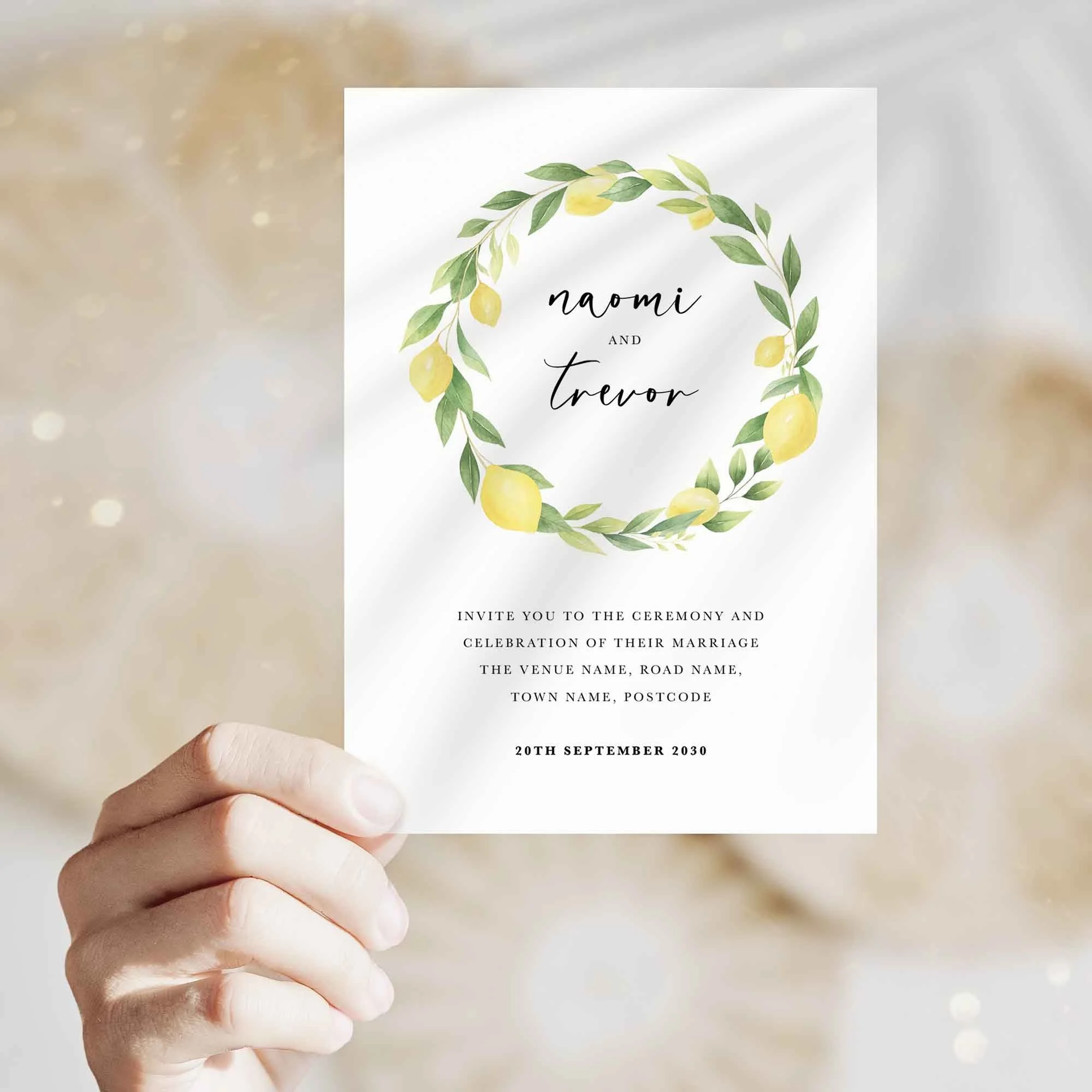 Hand holding Lemon Wreath wedding invitation showing size and printed design details