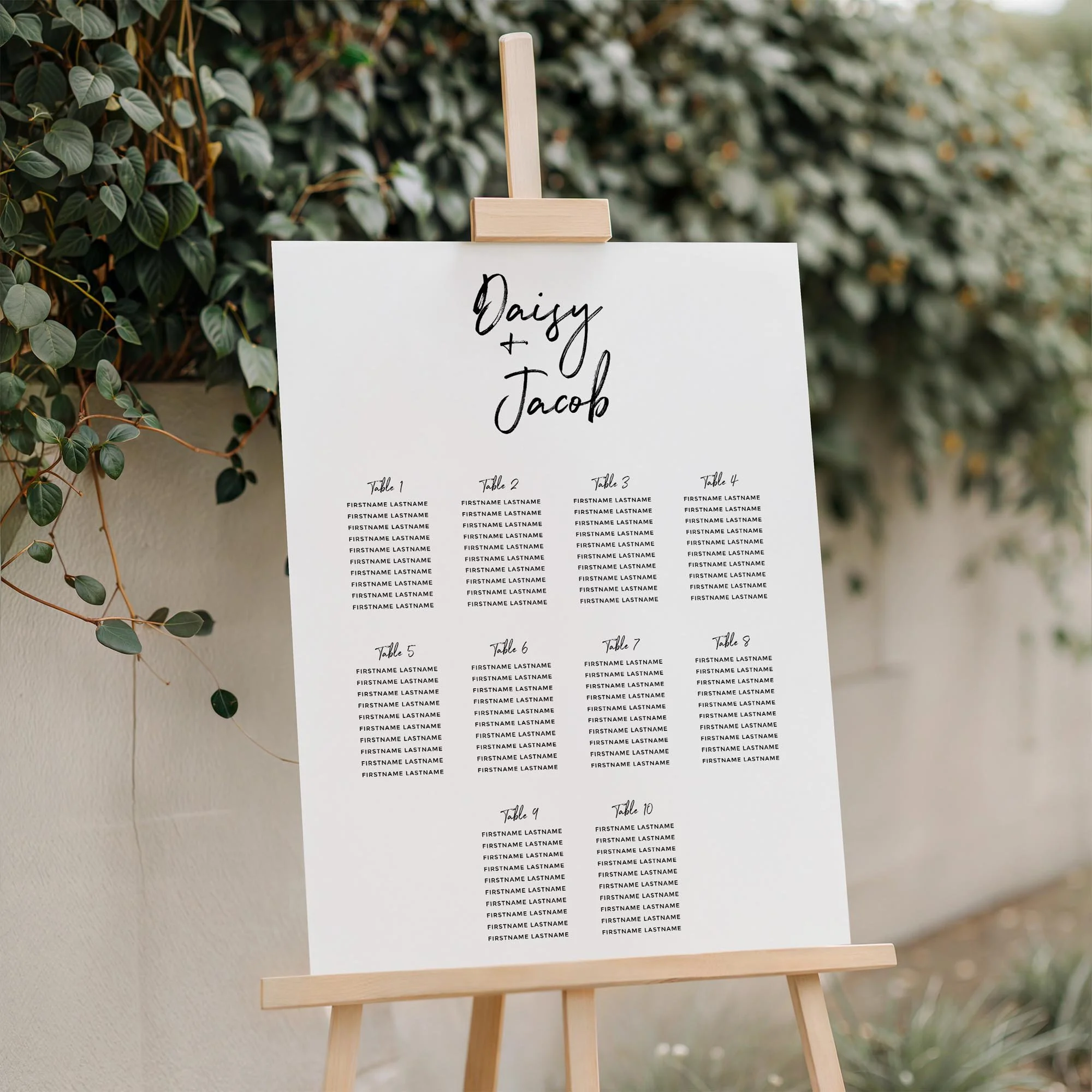 Close-up of the Signature Brush Stroke Font wedding seating plan board displayed outdoors