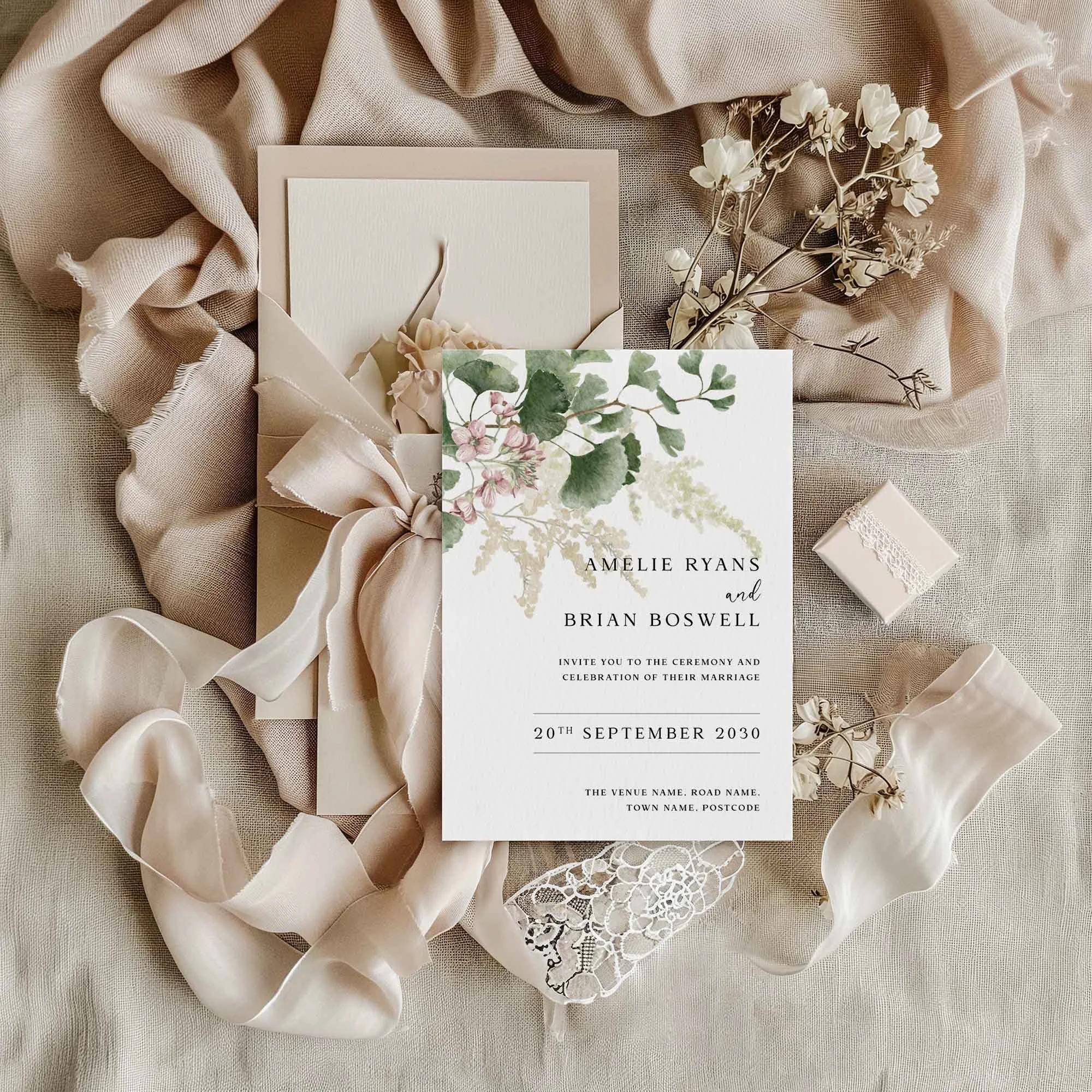 Forest Leaves wedding invitation styled in a flat lay environment with wedding props