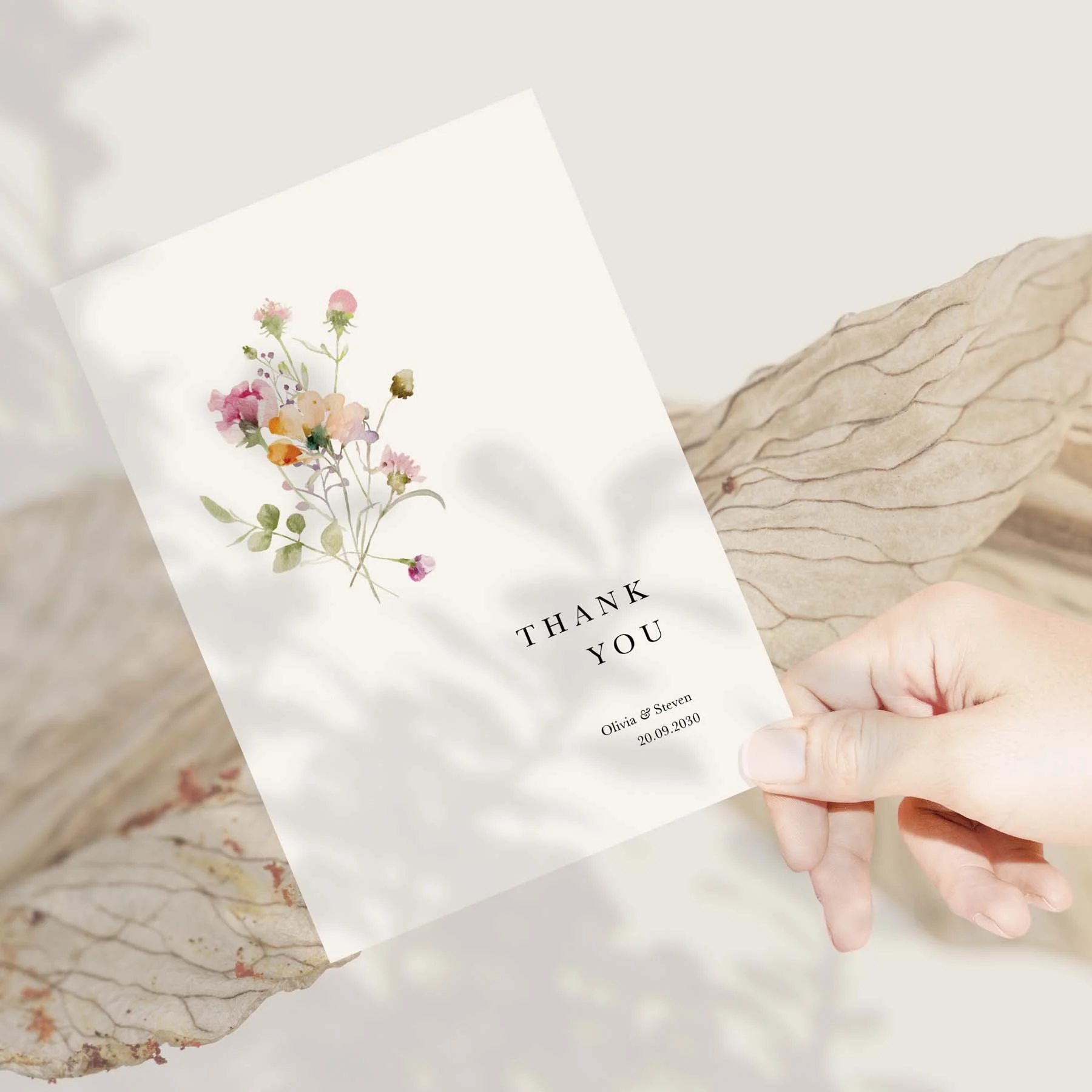 Hand holding a Pastel Floral wedding thank you card