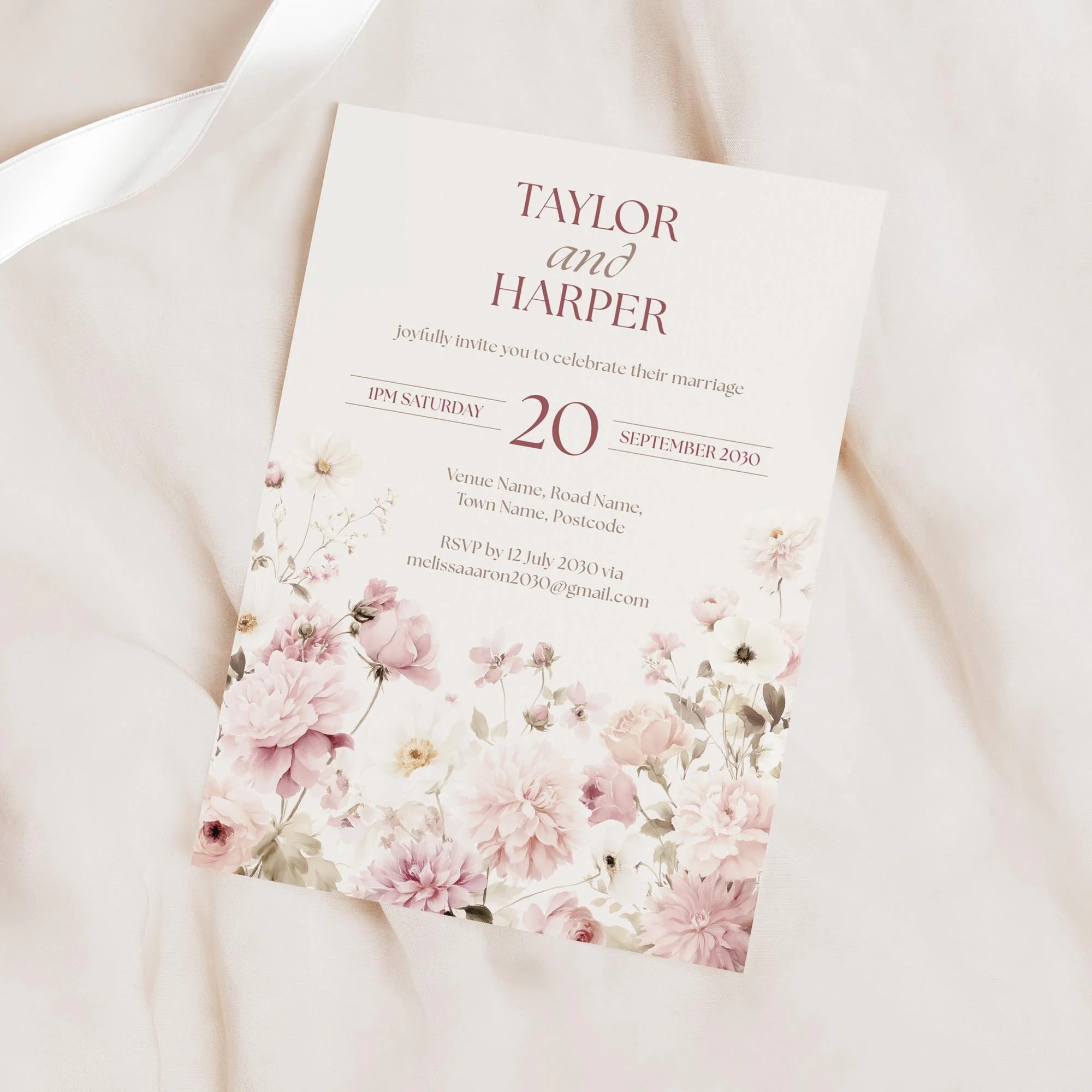 Minimal product shot of the Petal Wedding Invitation with blush pink florals along the bottom.