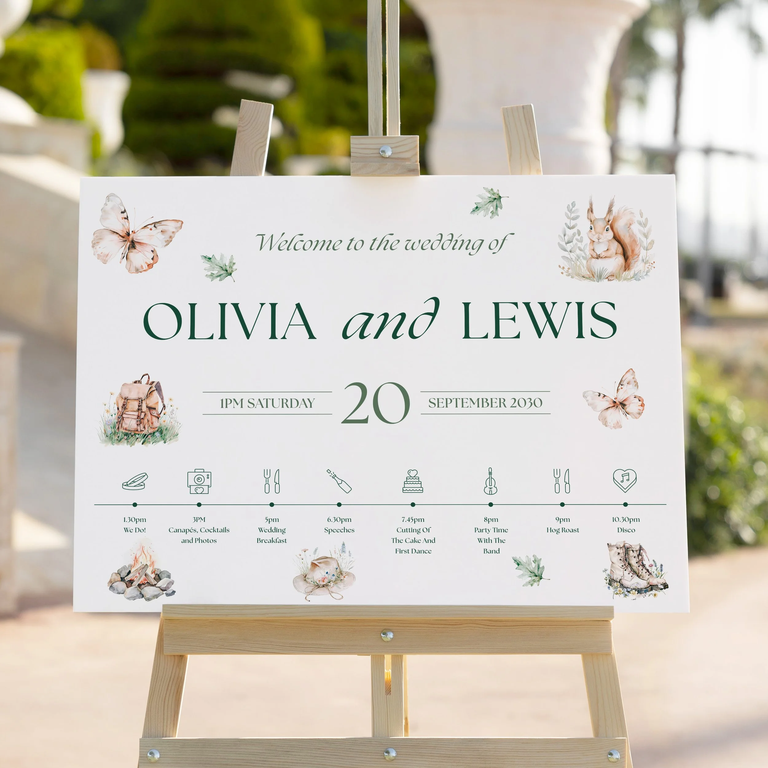 Close-up of Adventure Wedding Welcome Sign on easel showing leaves, butterflies, and rustic design.