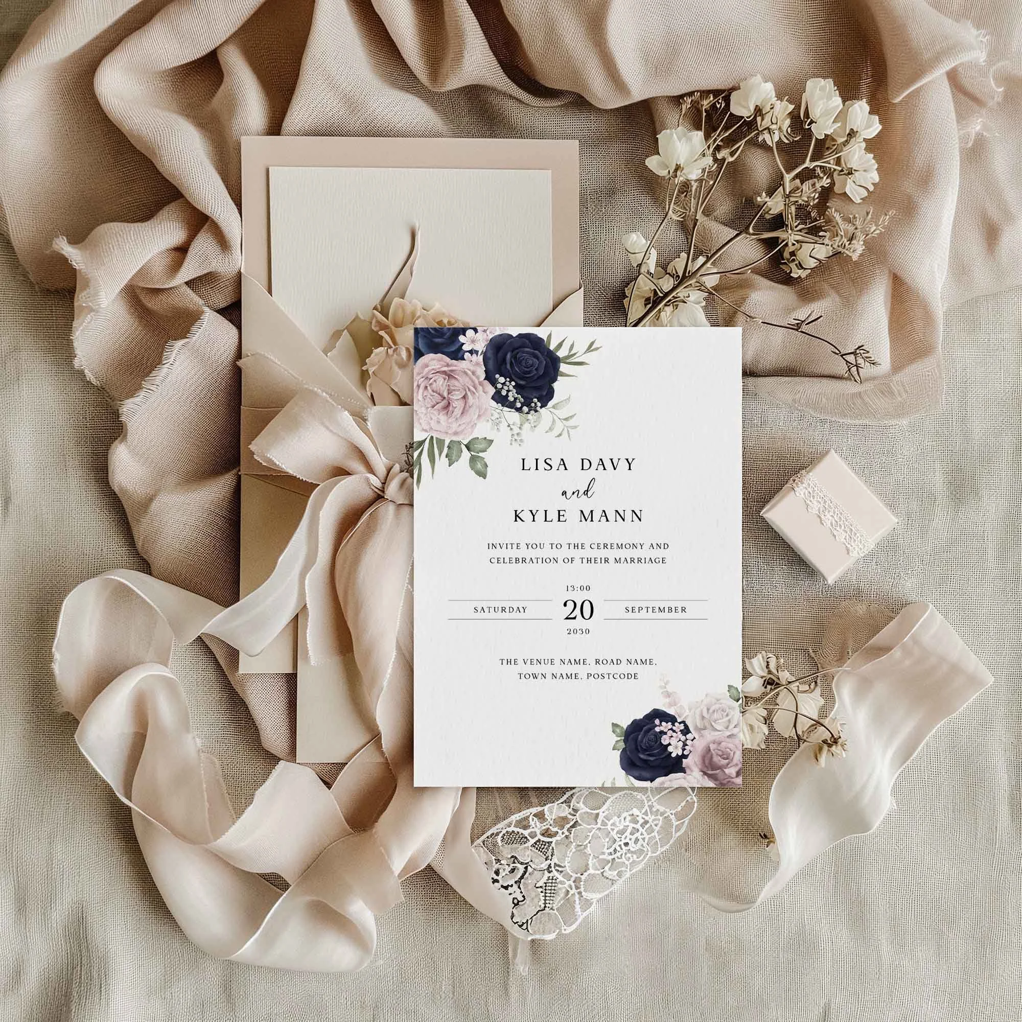 Navy and Blush Floral wedding invitation styled in a flat lay environment with wedding props