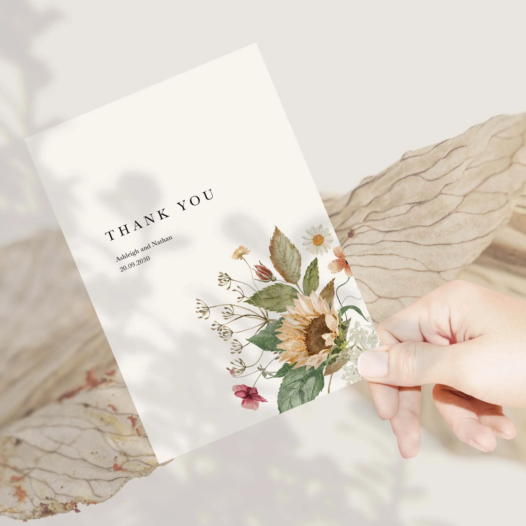 Hand holding an Autumn Sunflower wedding thank you card