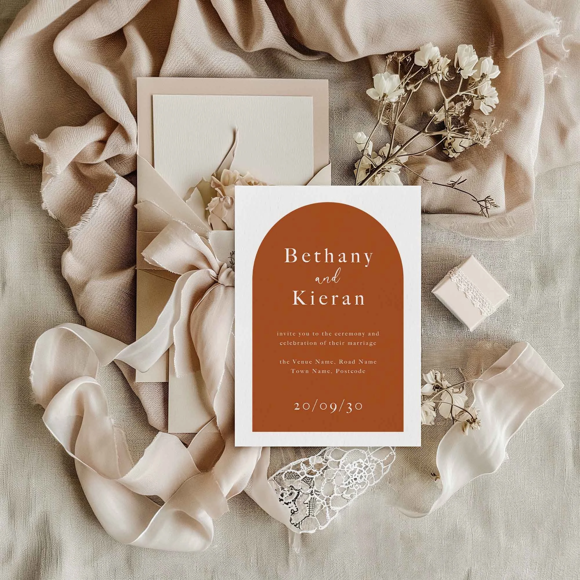 Orange Arch wedding invitation styled in a flat lay environment with wedding props