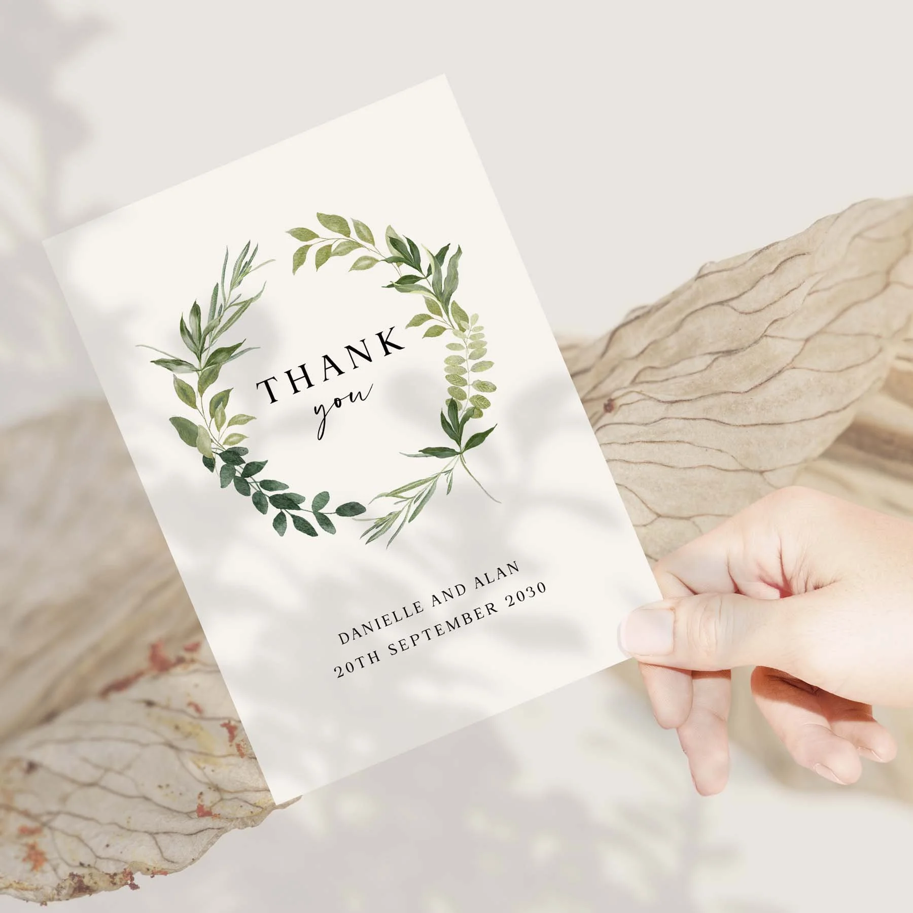 Hand holding a Greenery wedding thank you card