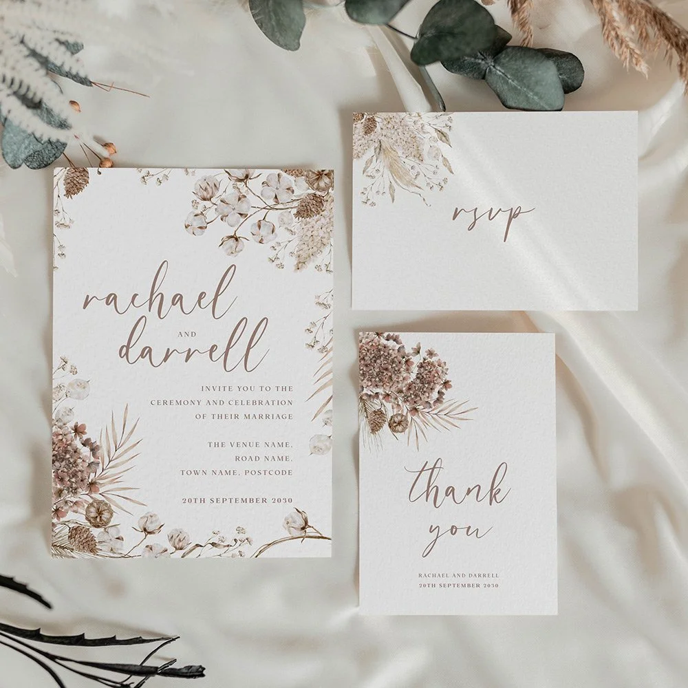 Boho wedding save the date card with pampas grass and dried florals, paired with modern calligraphy in a warm, neutral palette.