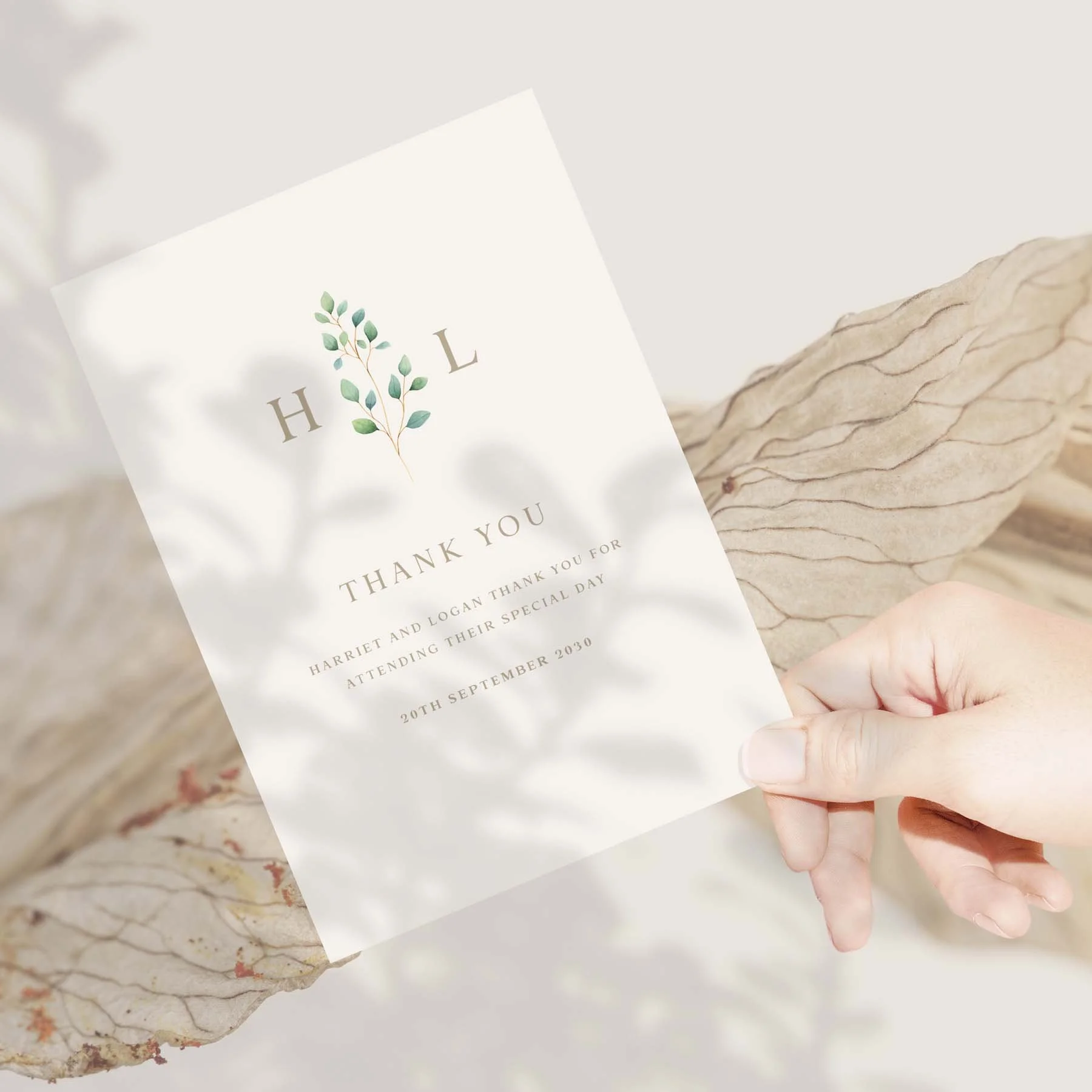 Hand holding a Eucalyptus Monogram wedding thank you card