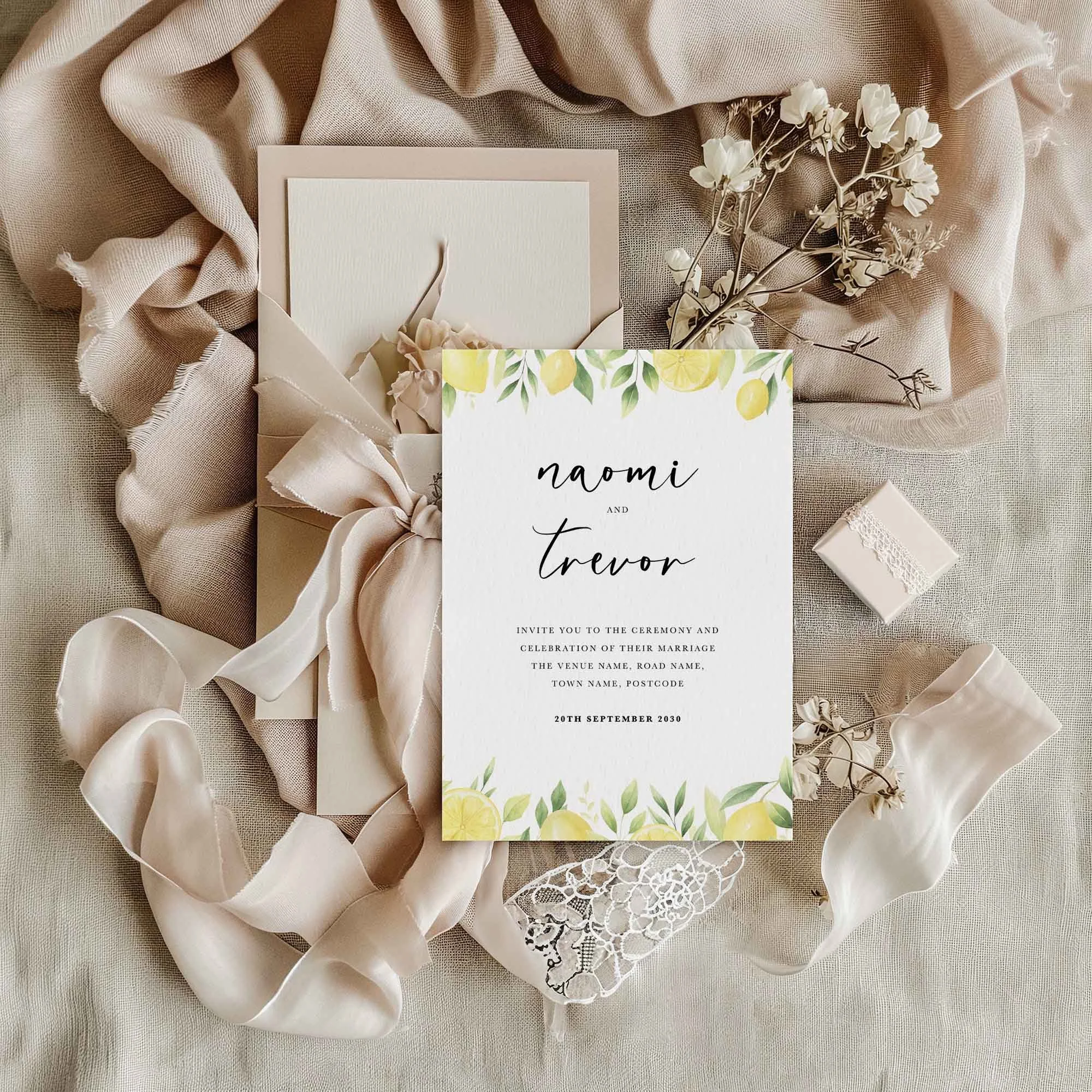 Lemon wedding invitation styled in a flat lay environment with wedding props