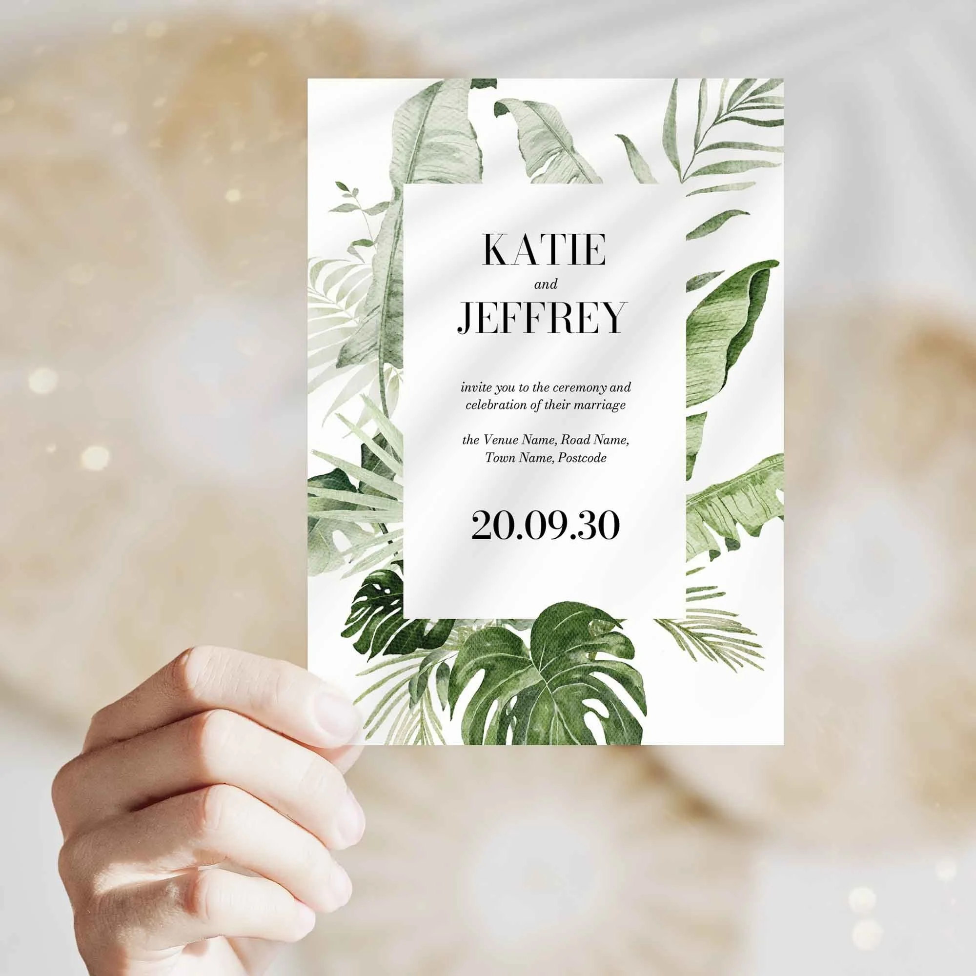 Hand holding Modern Tropical wedding invitation showing size and printed design details