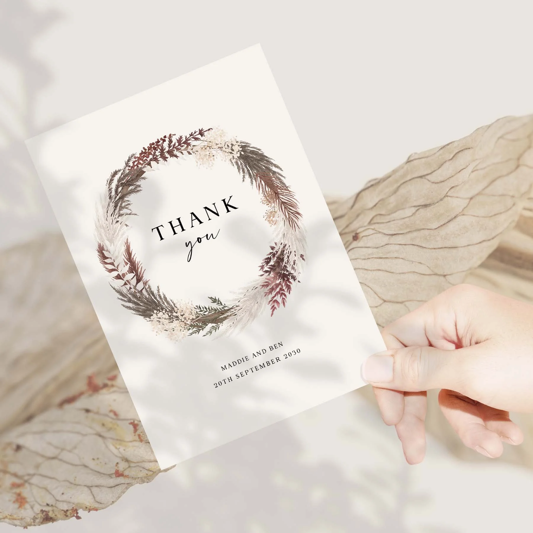 Hand holding a Blush Boho wedding thank you card