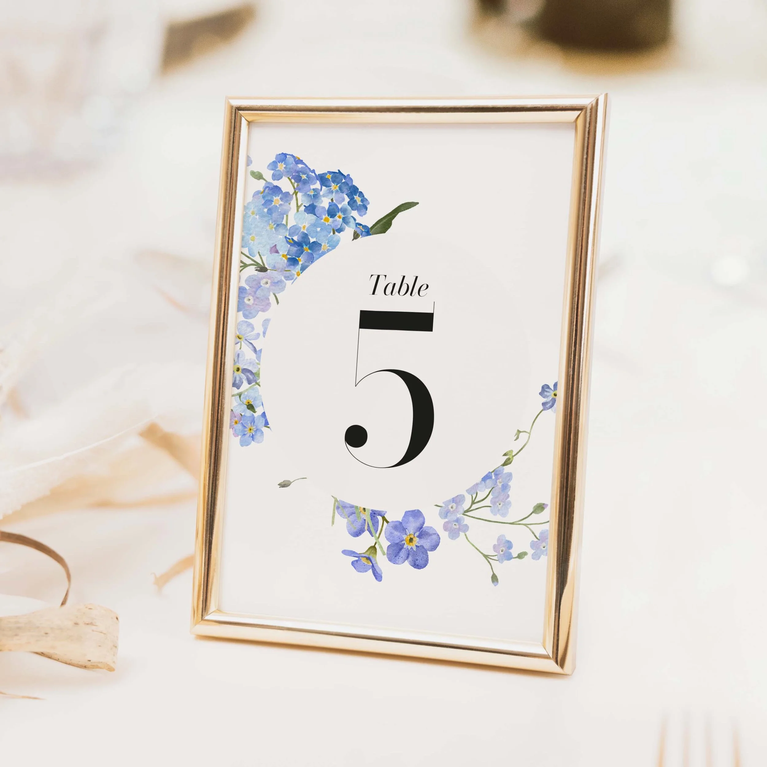 Forget Me Not wedding table number with blue watercolour forget-me-not floral illustration and bold numeral on luxury off-white card