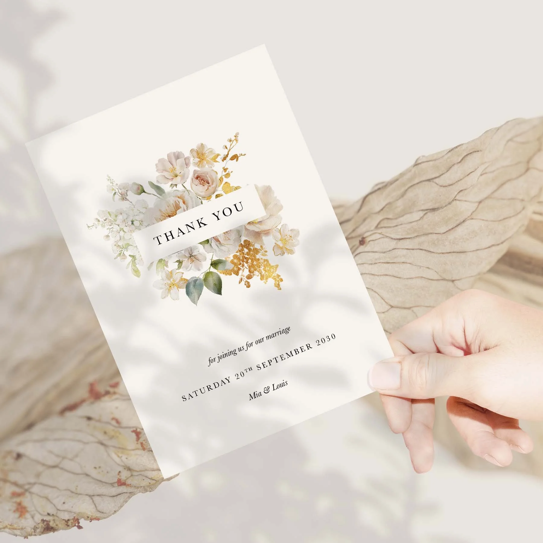 Hand holding a White and Gold Floral wedding thank you card