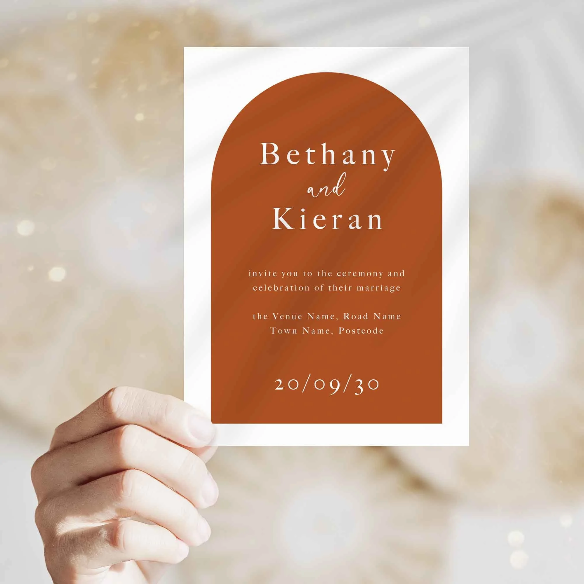Hand holding Orange Arch wedding invitation showing size and printed design details