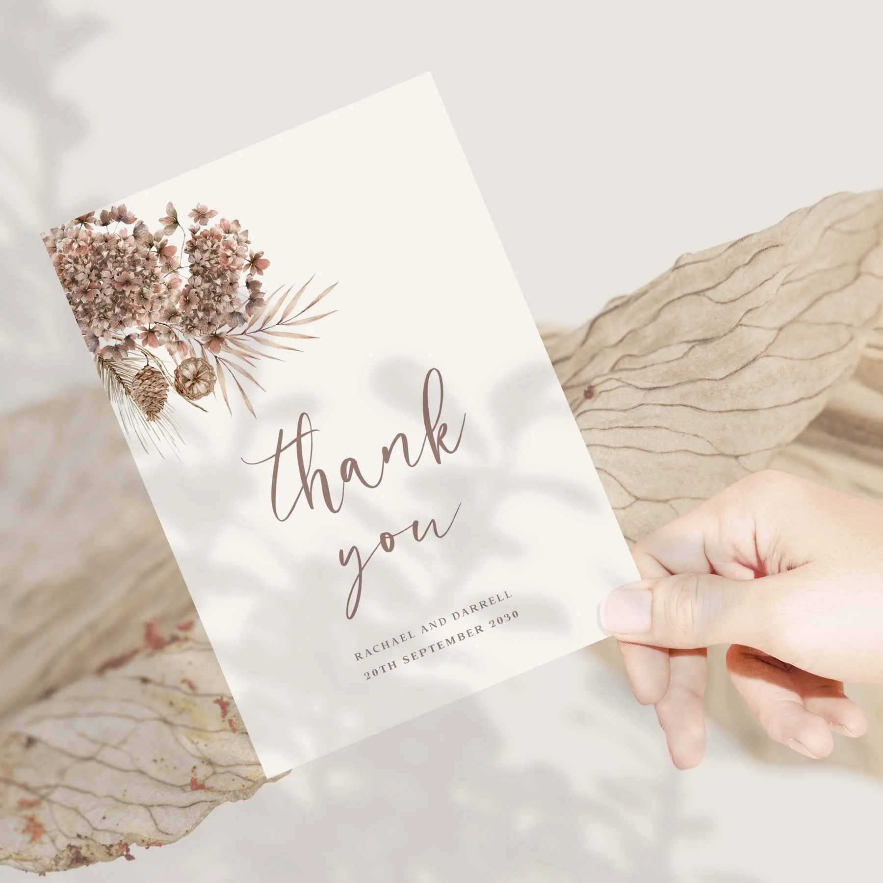 Hand holding an Earth Toned Boho wedding thank you card
