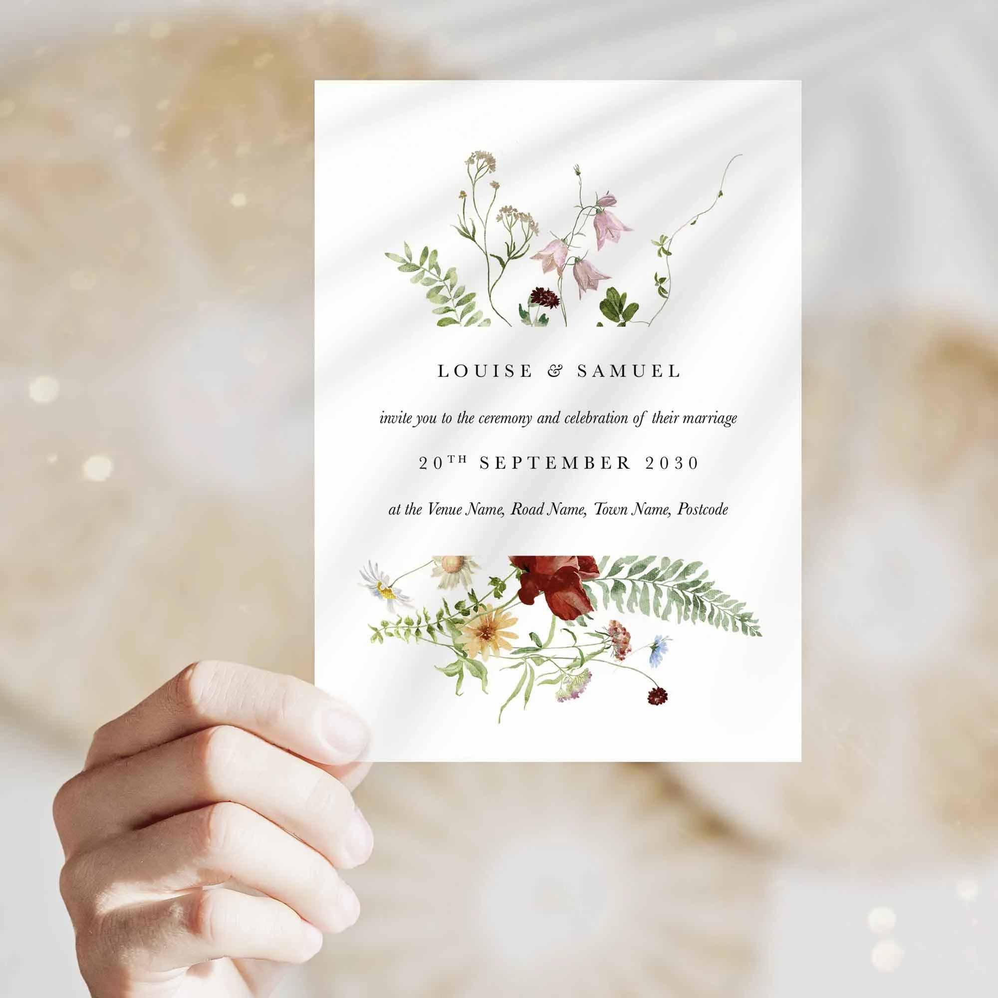 Hand holding Meadow Wildflowers wedding invitation showing size and printed design details