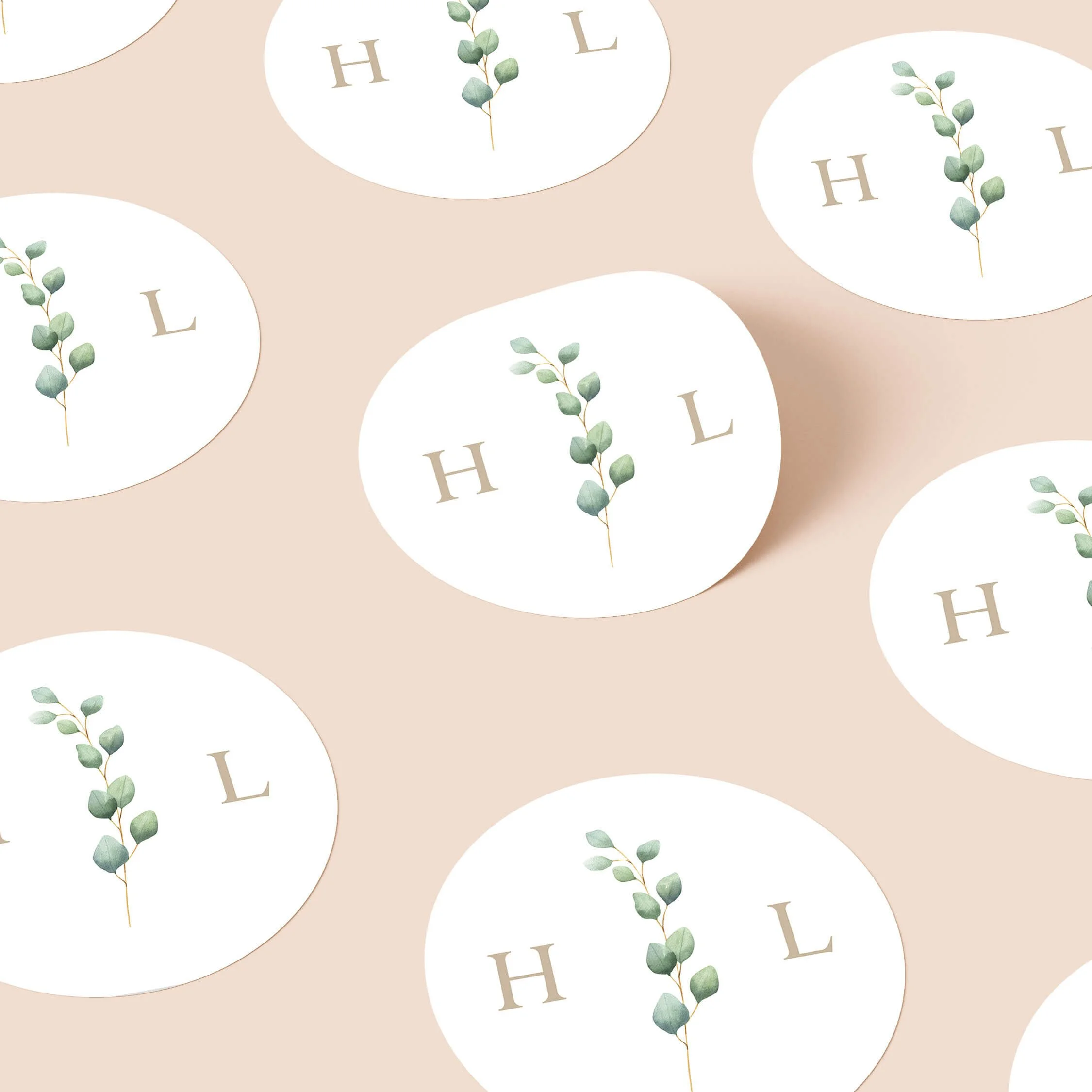 Eucalyptus Monogram wedding stickers with botanical stem and initials repeated on personalised round seals