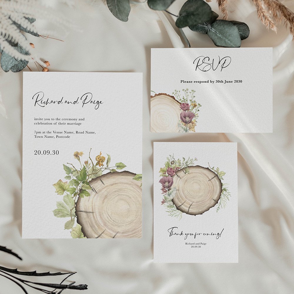 Rustic save the date card with watercolour wood slice, greenery and florals, featuring elegant calligraphy and a natural wedding design