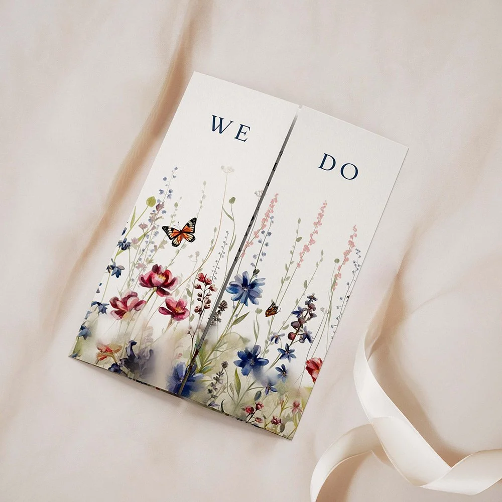Field Collection Navy gatefold wedding invitation closed, featuring red and navy blue wildflowers with elegant serif typography