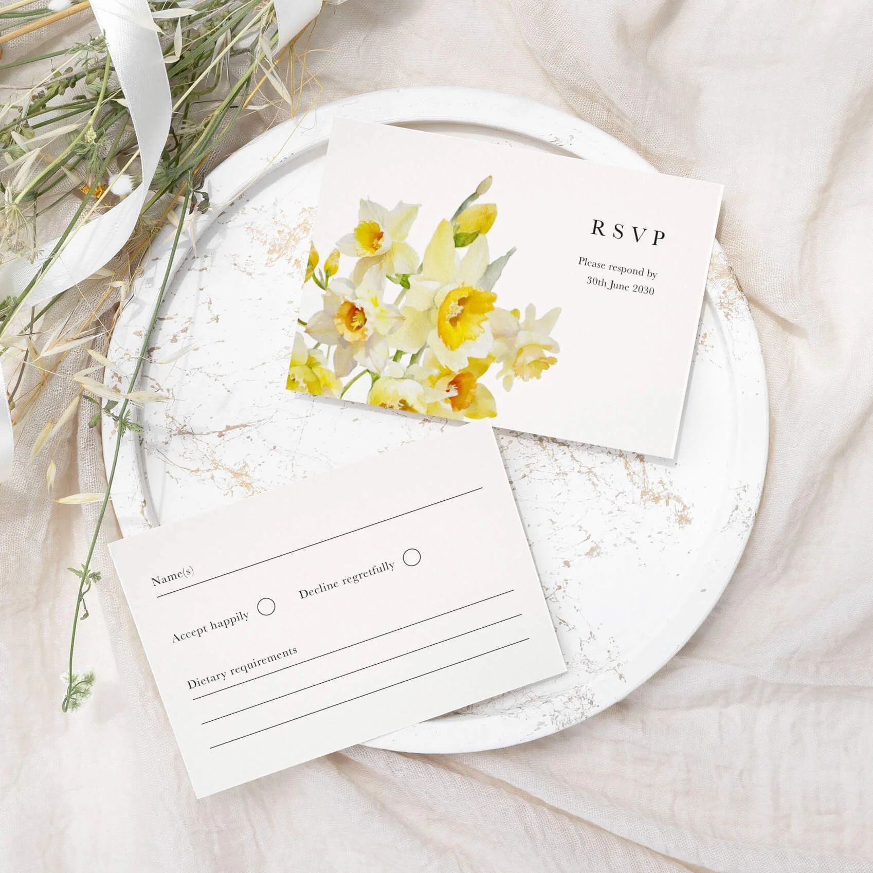 Daffodil wedding RSVP card with yellow daffodil floral illustration and elegant typography on luxury off-white card