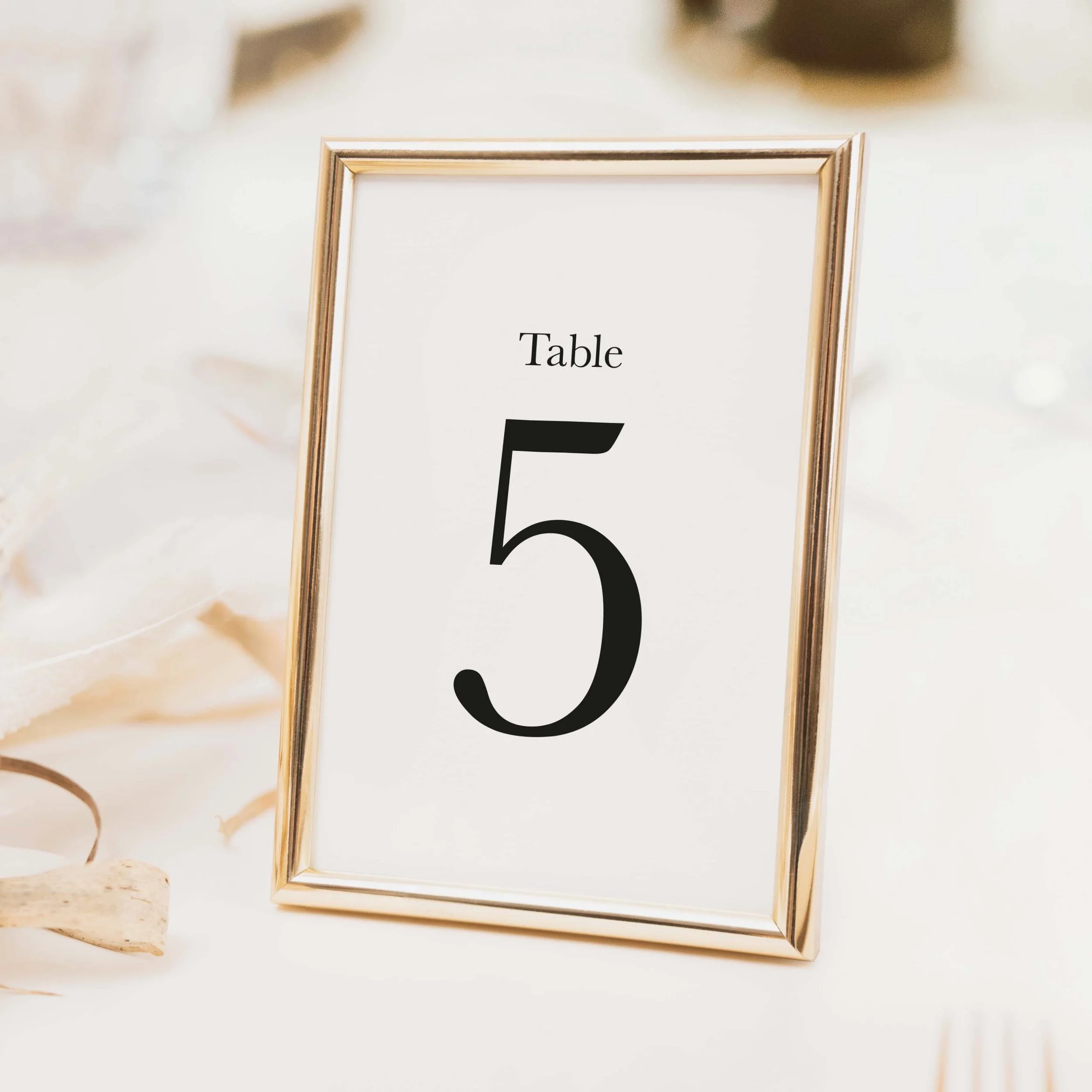 Minimal wedding table number with large bold clean typography and no illustration on luxury off-white card