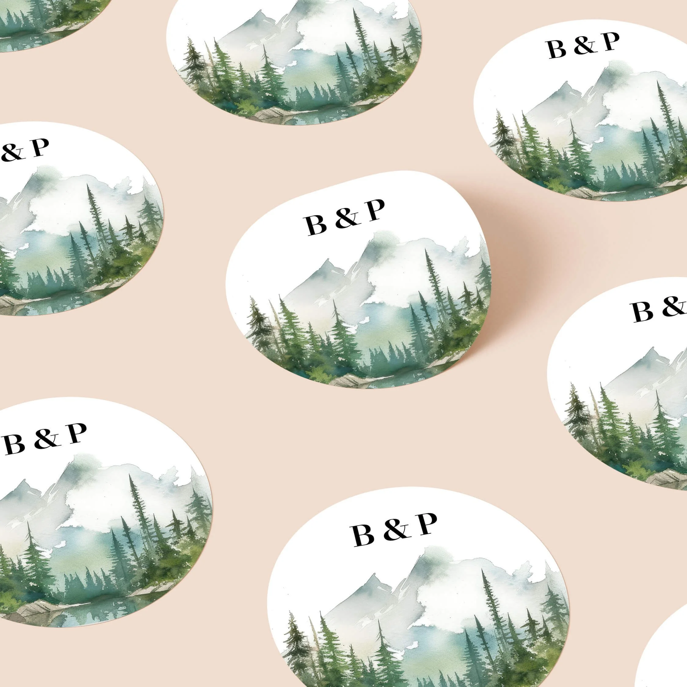 Wilderness personalised wedding stickers with watercolour mountain and pine forest landscape design on round stickers