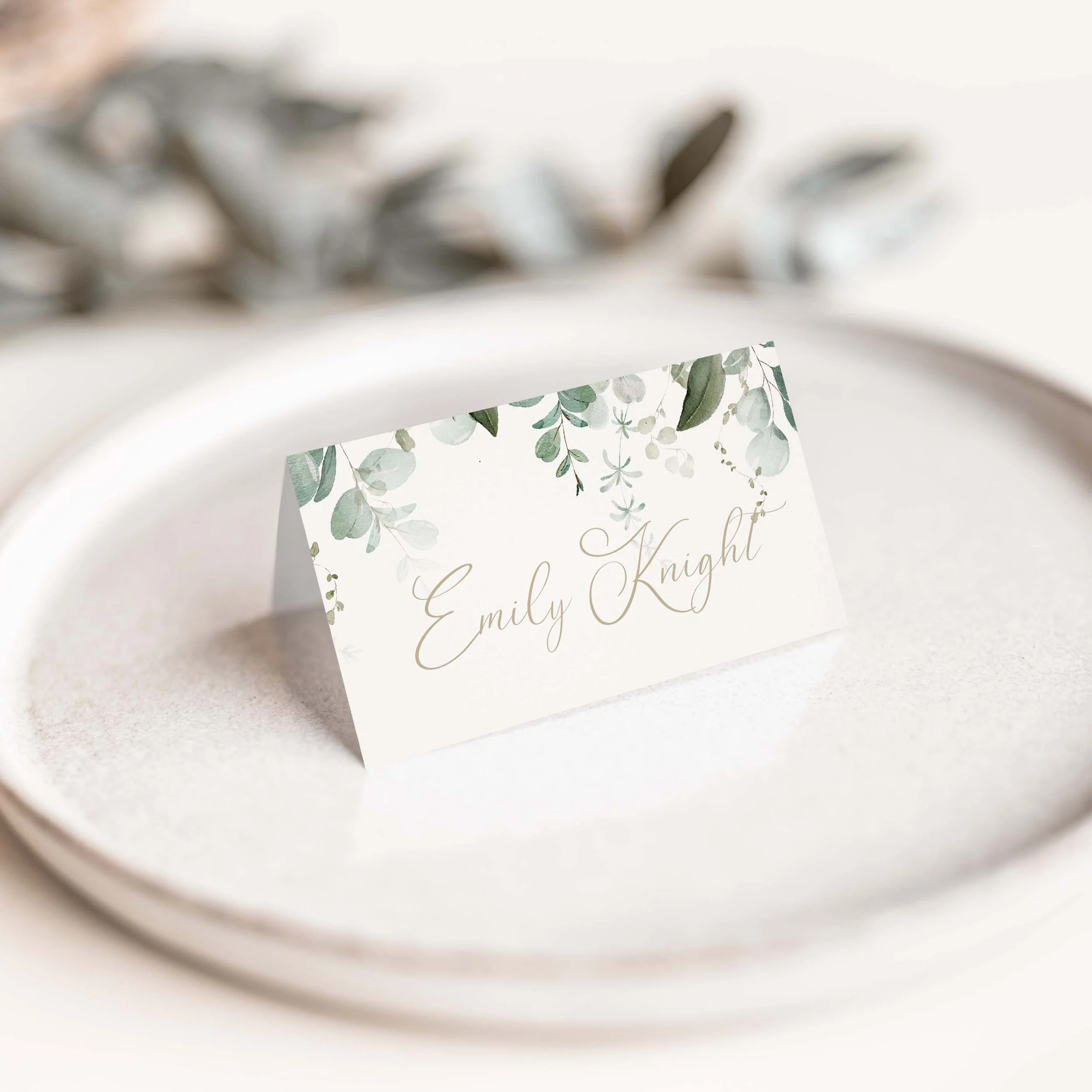 Emerald Forest wedding place card with rich green foliage botanical illustration and elegant script typography on luxury off-white card