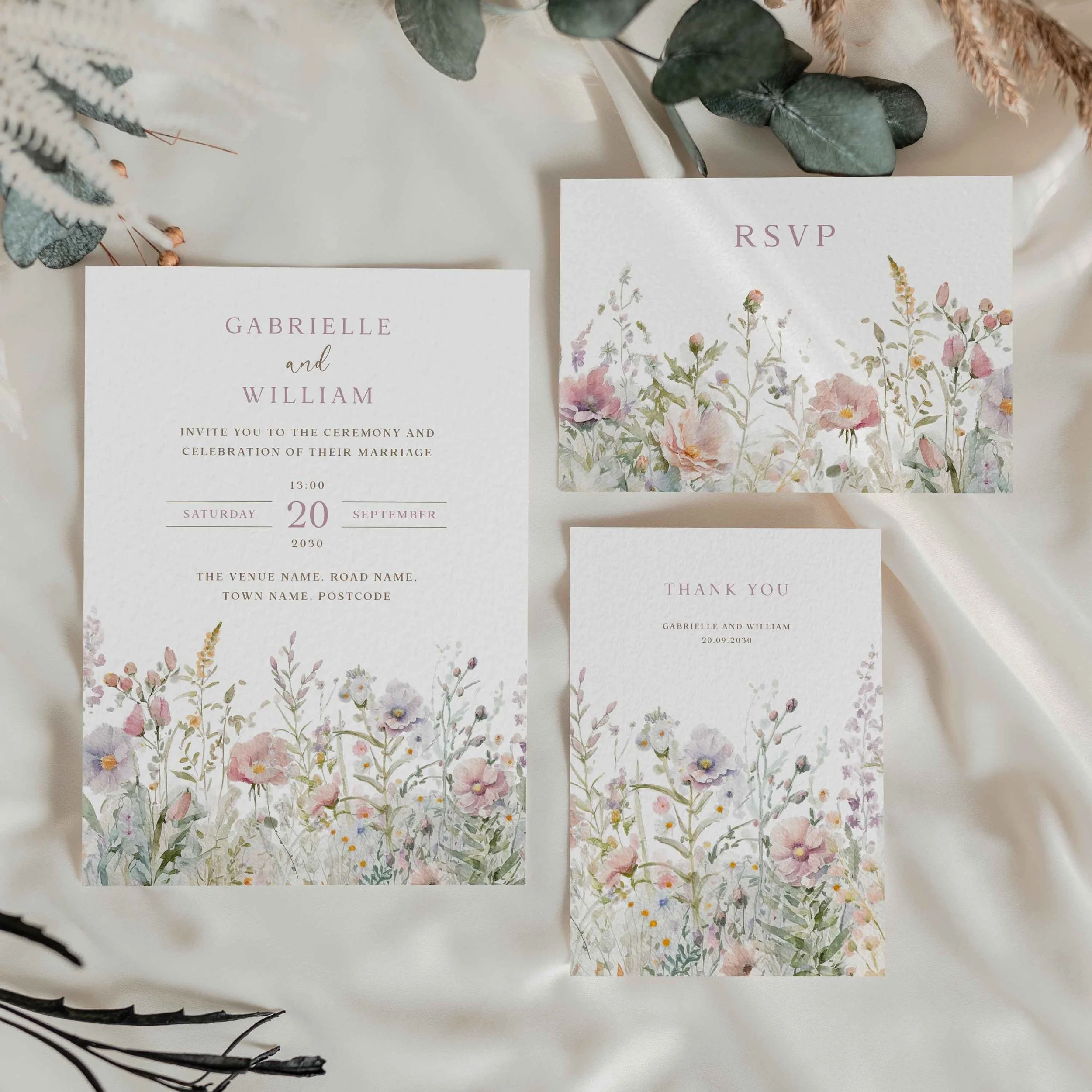 he Field Powder wedding stationery collection showing RSVP cards with delicate meadow wildflowers in soft powder pastel tones