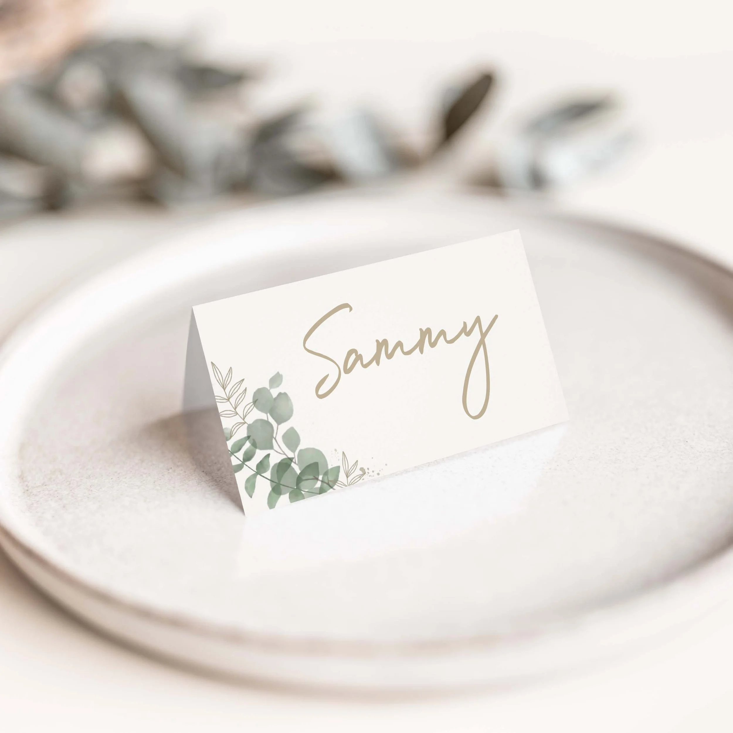 Eucalyptus wedding place card with greenery foliage and calligraphy script