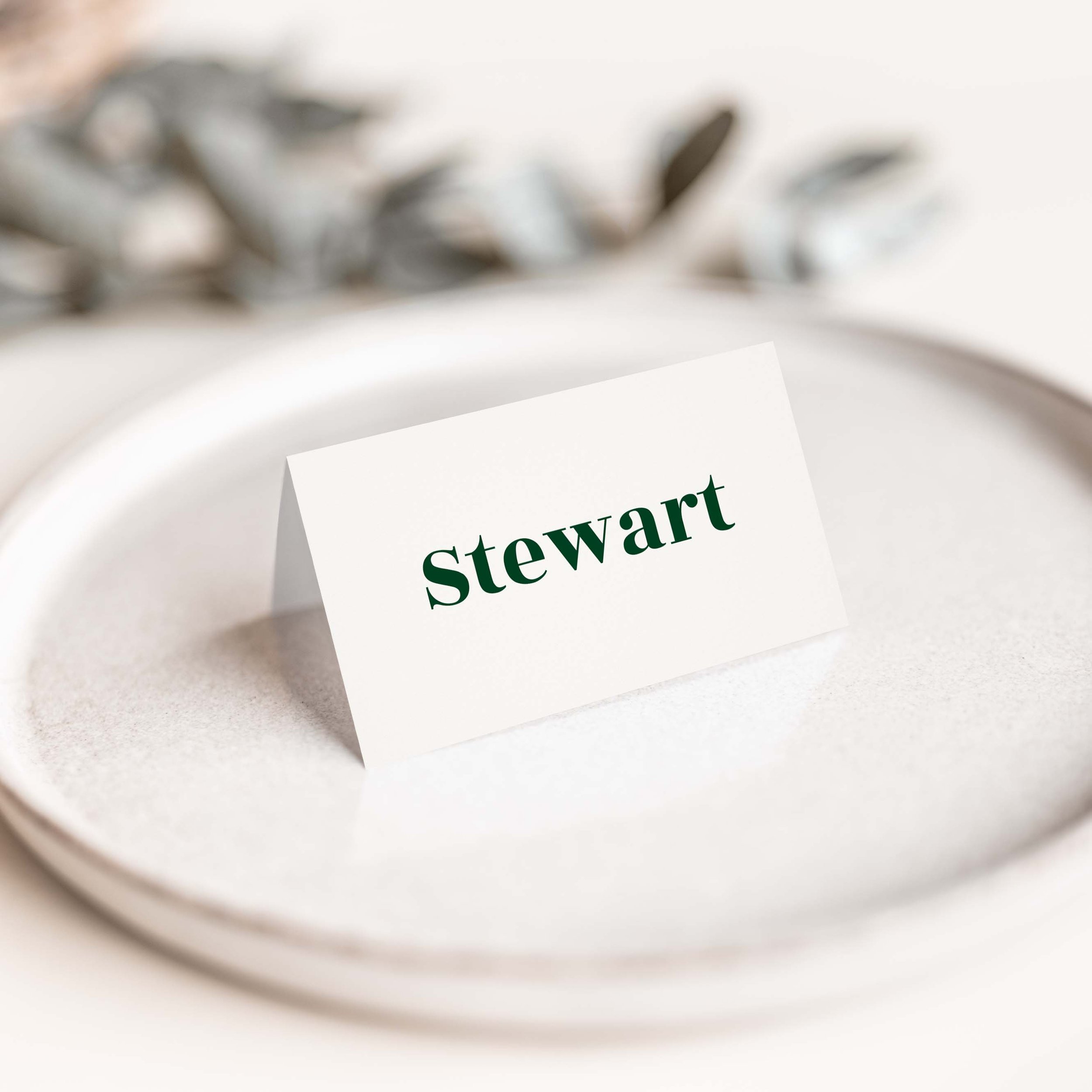 Typography Green wedding place card with large bold forest green calligraphy script guest name on luxury off-white card
