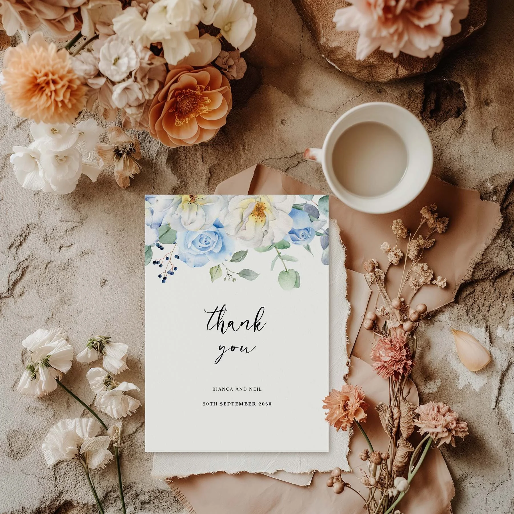 Blue Floral wedding thank you card styled with flowers and stationery details
