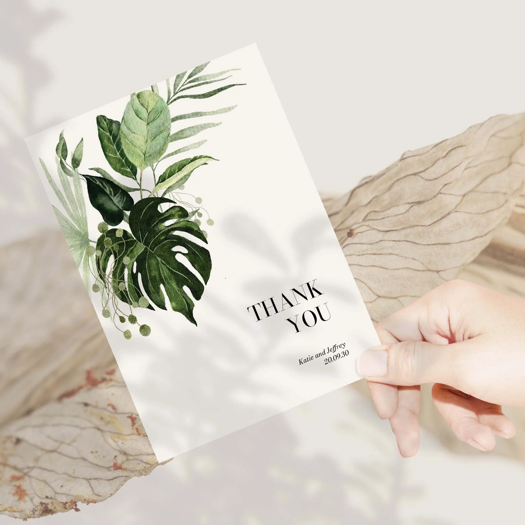 Hand holding a Tropical Leaves wedding thank you card