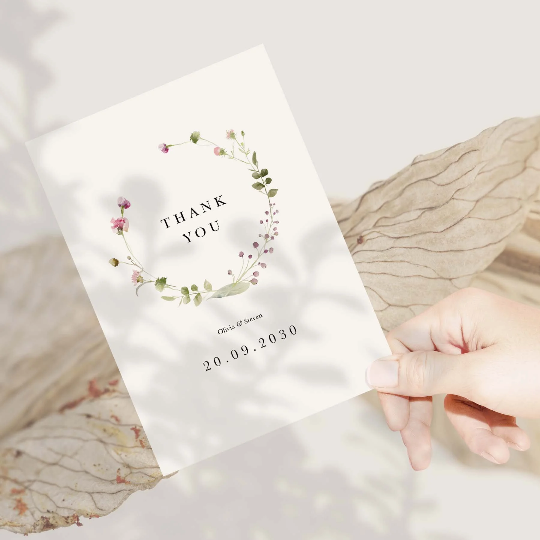 Hand holding a Delicate Floral Circle Around Names wedding thank you card