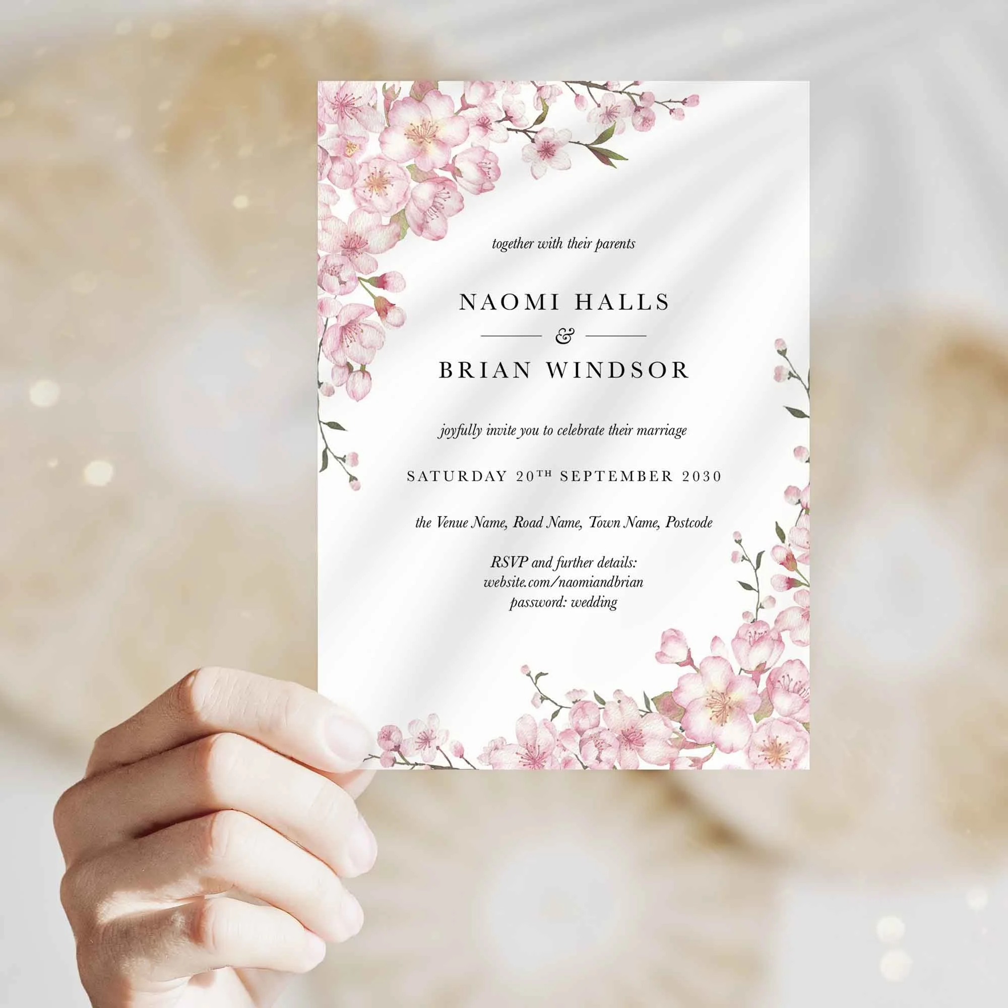 Hand holding Cherry Blossom wedding invitation showing size and printed design details