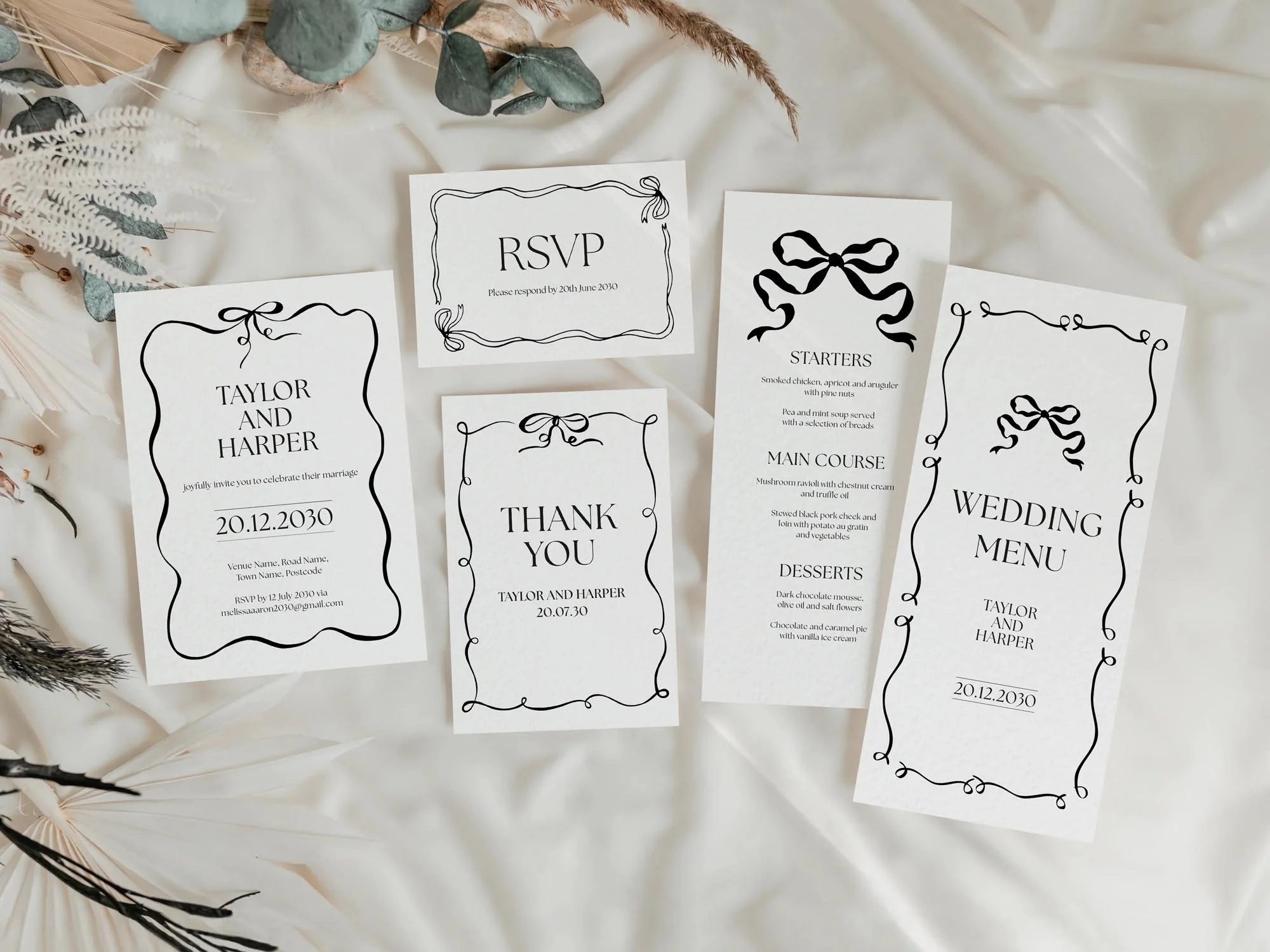 Black and white wedding invitations featuring a had drawn ribbon and bow