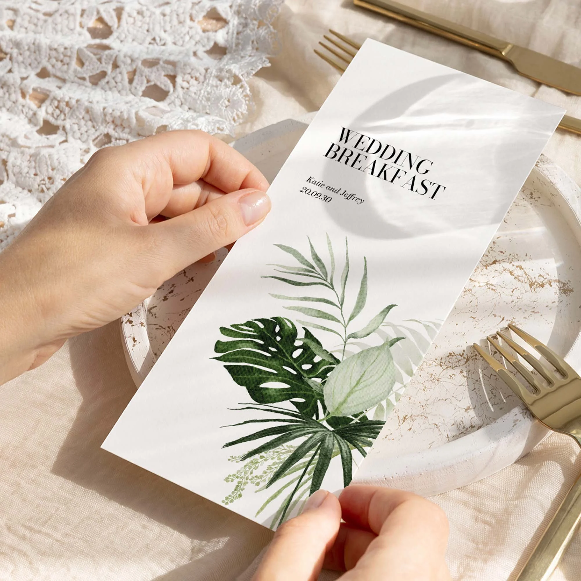 Hand holding Tropical Leaves wedding menu card showing size and printed design details