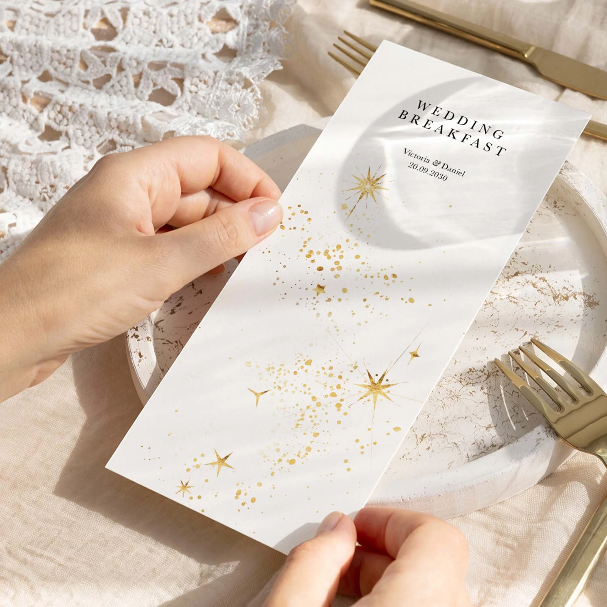 Hand holding Celestial wedding menu card showing size and printed design details