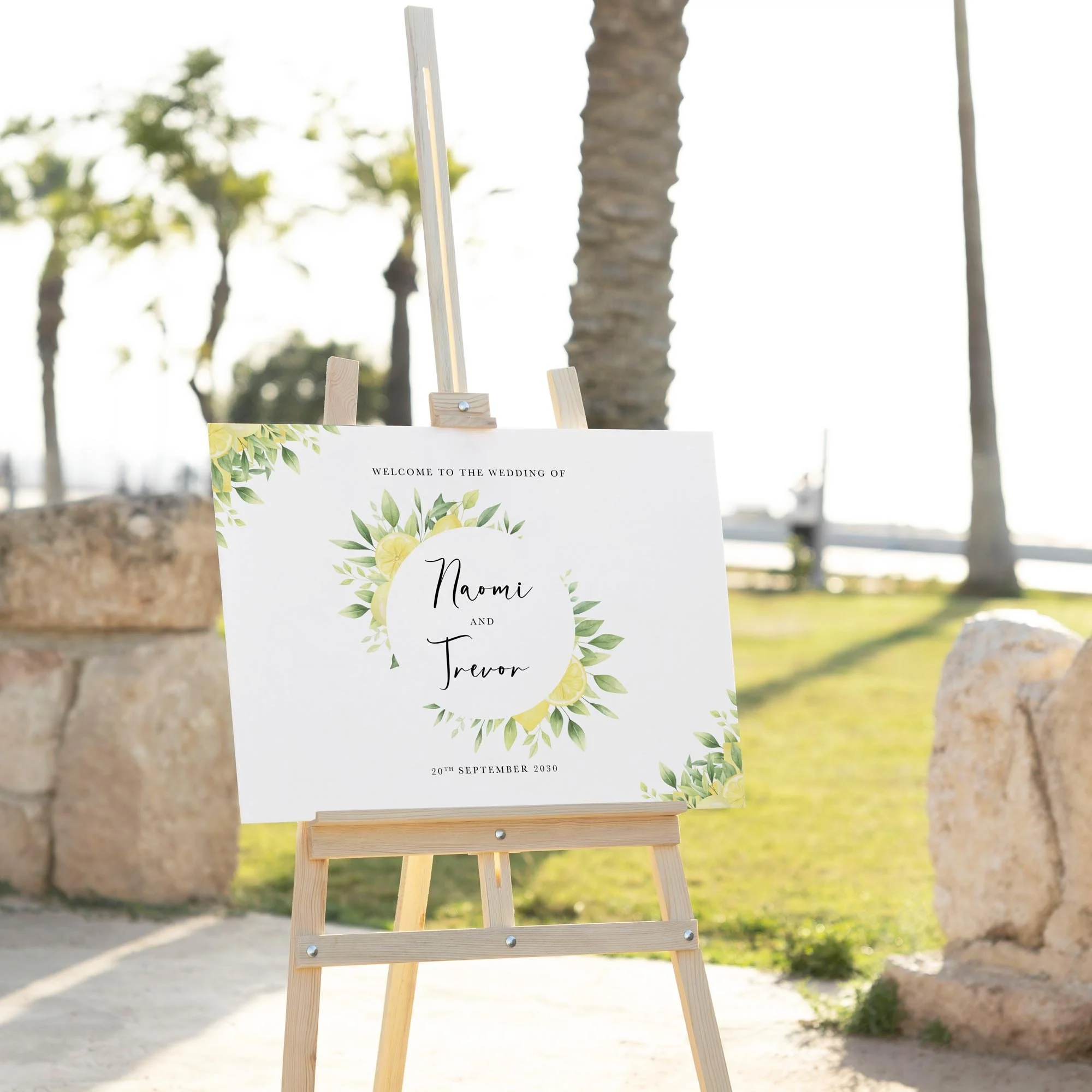 Lemon wedding welcome sign displayed outdoors at a wedding venue on an easel